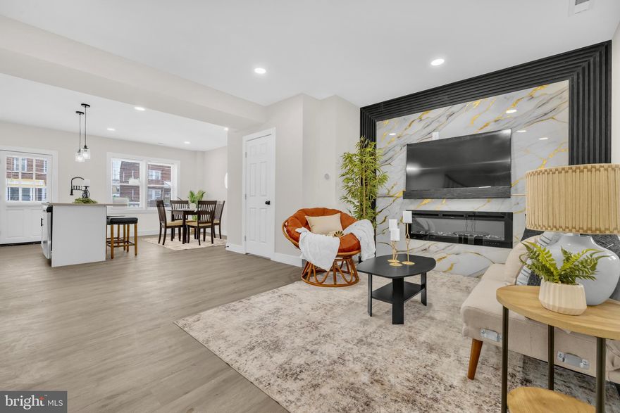 Welcome home to this stunning, completely renovated end-unit featuring 4 bedrooms, 2 full baths, and 1 half bath. The main level boasts gleaming hardwood floors and a bright open-concept layout perfect for modern living and entertaining. Enjoy a stylish kitchen with stainless steel appliances, a large island with seating options, and seamless flow into the separate dining area. A convenient powder room is also located on the main level.

The inviting living space is highlighted by a striking accent wall and a built-in fireplace, creating a warm and elegant focal point. Step outside to a spacious deck overlooking the backyard—ideal for relaxing or hosting gatherings. The home also offers a parking pad for added convenience.

The walkout basement provides excellent additional living space, perfect for entertaining, along with a bonus room featuring a closet that can be used as an office, guest room, or flex space.

Additional features include a covered front porch, backyard, and the privacy of an end-unit location. This move-in-ready home combines modern upgrades, functional design, and outdoor living—an absolute must-see!