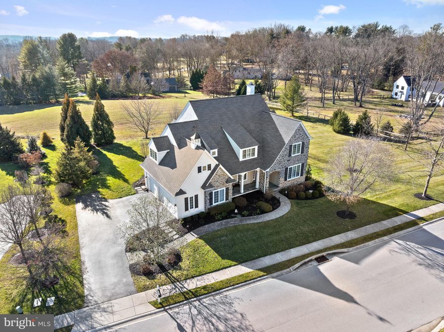 Located in the  desirable community of Andover,  this meticulously designed property blends functionality with elegance.  A timeless facade of mica stone and siding with an enchanting covered front porch set the stage for this residence on a premium lot overlooking open space.  As you enter, high ceilings, an open staircase  with a charming window seat, and abundant windows bathe the space in natural light.   A formal Living Room and a holiday sized Dining Room flank the view through Foyer, with beautiful millwork and site finished  hardwood.  French doors with a transom lead from the Living Room to the Study with custom built in's.  The gourmet kitchen is a chef's delight, featuring  a top of the line stainless steel appliance package, including a Wolf six burner range with double oven, french door refrigerator, microwave and a Bosch dishwasher.  The dazzling oversized island  and custom upgraded cabinetry features the small custom details you'd wish for - a  plate rack, glass doored display cabinets and an appliance garage - all combine to make it the perfect space for both everyday use and entertaining.  A handsome Butlers Pantry joins the Kitchen and Dining Room, while a walk in pantry is perfectly sized for ample storage.     A spacious fireside family room with coffered ceiling,  gas fireplace, a custom mantle  and bookcases. and a delighful glassed sided  Morning Room with cathedral ceiling which opens to two outdoor living spaces.  A charming  screened porch overlooking a park like backyard, and a stone patio  with curved wall are perfect for al fresco dining, summer barbecues or simply enjoying the tranquility of the surroundings.   The luxurious Primary Suite is a true retreat, offering a bedroom with tray ceiling,  two outfitted walk in closets and a spa like bath with soaking tub, frameless door oversized shower, two separate vanities and private water closet.  Bedroom #2 has an en suite bath and walk in closet.  Bedroom #3 and #4 include dormer sitting areas and share a compartmentalized bath.  A super convenient laundry room with utility sink and cabinetry compete the second floor.  The finished Lower Level includes a custom wet bar with wine fridge, large rec room and entertiang space, a powder room and a separate exercise or craft room.   Efficient Geo thermal HVAC, unsuprassed quality, newer roof, low taxes, public water and sewer.  The exceptional location is nestled between Newtown Square,  West Chester and  Media and affords residents an easy commute to Delaware, the Main Line and Philadelphia Airport.  This home exceeds expectations with its  blend of luxury, comfort and quality craftsmanship