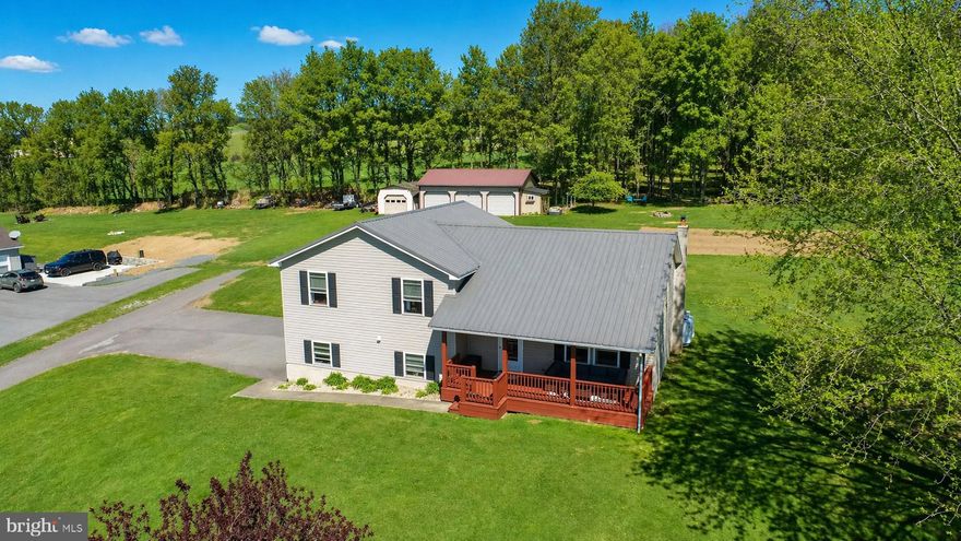 Enjoy peaceful country living with beautiful scenic views from this well-maintained 3 bedroom, 3 bath home just outside of Accident. Perfectly positioned on a 1.54-acre lot, the property offers the space and privacy of rural living while still being conveniently located to nearby amenities and Deep Creek Lake. Inside, the home features comfortable living spaces with generously sized bedrooms and a lower-level family room that provides the perfect spot for relaxing, entertaining, or hosting guests. Step outside onto the welcoming covered front porch where you can unwind and take in the surrounding countryside. Car enthusiasts, hobbyists, or anyone needing extra space will appreciate the integral garage along with an impressive detached three-car garage and an additional storage building—offering plenty of room for vehicles, equipment, or workshop space. With its beautiful setting, versatile space, and well-cared-for condition, this property is a wonderful opportunity to enjoy the best of Garrett County living!