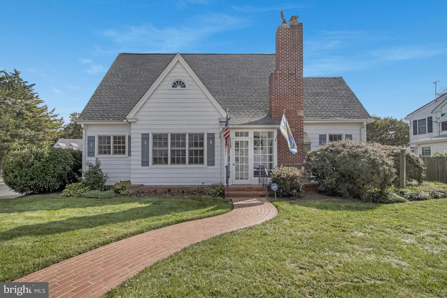 Perfectly positioned on DeVries Circle in the heart of Lewes, this extraordinary five-bedroom, four-bath historic residence is a true architectural gem—rich in provenance, thoughtfully expanded, and beautifully updated for modern living.

Steeped in local history, the home uniquely incorporates elements from the iconic Cape Henlopen Lighthouse, lost at sea in 1926. Among its treasured features, the arched front door is said to have originated from the lighthouse keeper’s cottage—an irreplaceable detail that anchors the home’s storied past.

The main residence welcomes you with abundant natural light, timeless built-ins, and a gas fireplace that creates a warm and inviting gathering space. Two first-floor primary suites offer exceptional flexibility. The main primary retreat features an oversized walk-in closet, dual vanities, and a beautifully tiled step-in shower designed with both comfort and sophistication in mind.

Upstairs, two additional bedrooms with walk-in closets provide generous accommodations, along with a spacious attic offering extensive storage. Through a stunning breezeway, you’ll discover a private secondary primary suite complete with built-ins, a wood-burning fireplace, full bath, and loft—ideal for guests, multigenerational living, or a secluded retreat.

The refinished basement has been thoughtfully transformed to include an additional bedroom, a versatile flex room, and a distinctive speakeasy—perfect for entertaining in style.

Blending historic integrity with meaningful enhancements, the home has been expanded to include two additional bedrooms and two full baths while preserving its original character. Modern comforts include three-zoned geothermal heating and cooling and Marvin Integrity windows throughout.

Outdoors, a stunning courtyard-style backyard offers exceptional privacy with a fenced enclosure and a versatile shed equipped with a mini-split system—perfectly suited for a gym, studio, or additional flex space.

Enjoy an unparalleled lifestyle just moments from the scenic Junction & Breakwater Trail, the beloved Station on Kings, and the Lewes Public Library—with downtown Lewes less than half a mile away.

This is more than a home; it is a rare opportunity to own a distinctive piece of Lewes history