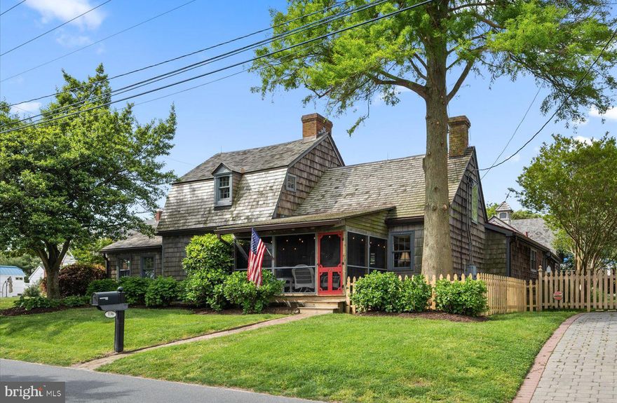 Welcome to 136 Gills Neck Road in the picturesque town of Lewes, Delaware. Rich in history, the Fisher House is a historic waterfront home that dates back to 1680. This 5 bedroom, 3.5 bath, canal front home tastefully blends the allure of the past with modern conveniences.  Lush landscape frames this charming shingle style home with a gambrel roofline and cozy front porch. Upon entry, you will be impressed with the beautifully preserved architectural elements including the four wood-burning fireplaces, wide plank hardwood floors, exposed beams, and intricate moldings at every turn. The updated addition, completed in the early 1990’s, seamlessly integrates modern amenities, providing a perfect balance of historic charm and contemporary living. The spacious kitchen includes vaulted ceilings with skylights, ample cabinetry, a pantry, electric cooktop, dual ovens, and a large island. From the kitchen, you will enter the family room which has excellent natural light from the skylights and oversized sliding door that leads to a custom Janco Greenhouse. This family room is ideal for relaxation, and perfectly mends indoor and outdoor living! The first level is also home to 3 spacious bedrooms each offering unique elements. The first-floor bedroom in the historic section offers vaulted ceilings with a loft and ensuite bath. The additional 2 bedrooms on the first level feature custom built-in shelving, and spacious walk-in closets. These rooms are adjacent to a hall bath featuring a stall shower, dual sinks, and a custom soaking tub. Approach the 2nd level by one of two original, hidden stairwells where you will find 2 more bedrooms, the 4th wood burning fireplace, a cozy sitting room and 1 full bathroom. Each room offers interesting angles and roof lines that you simply will not find in today’s architecture. As you meander outdoors, you will enjoy the privacy of the side courtyard complete with a spacious brick patio, 6’ privacy fence, beautiful landscaping, outdoor shower, and storage shed. The property continues to the adjacent, waterfront parcel, shaded by beautiful mature trees, manicured lawn and approximately 80 feet of rip rap along with a private 36’ floating dock complete with water and electric - ideal for your boat! Situated in the heart of historic Lewes, the Fisher House offers the utmost convenience and endless opportunities for recreation and exploration!