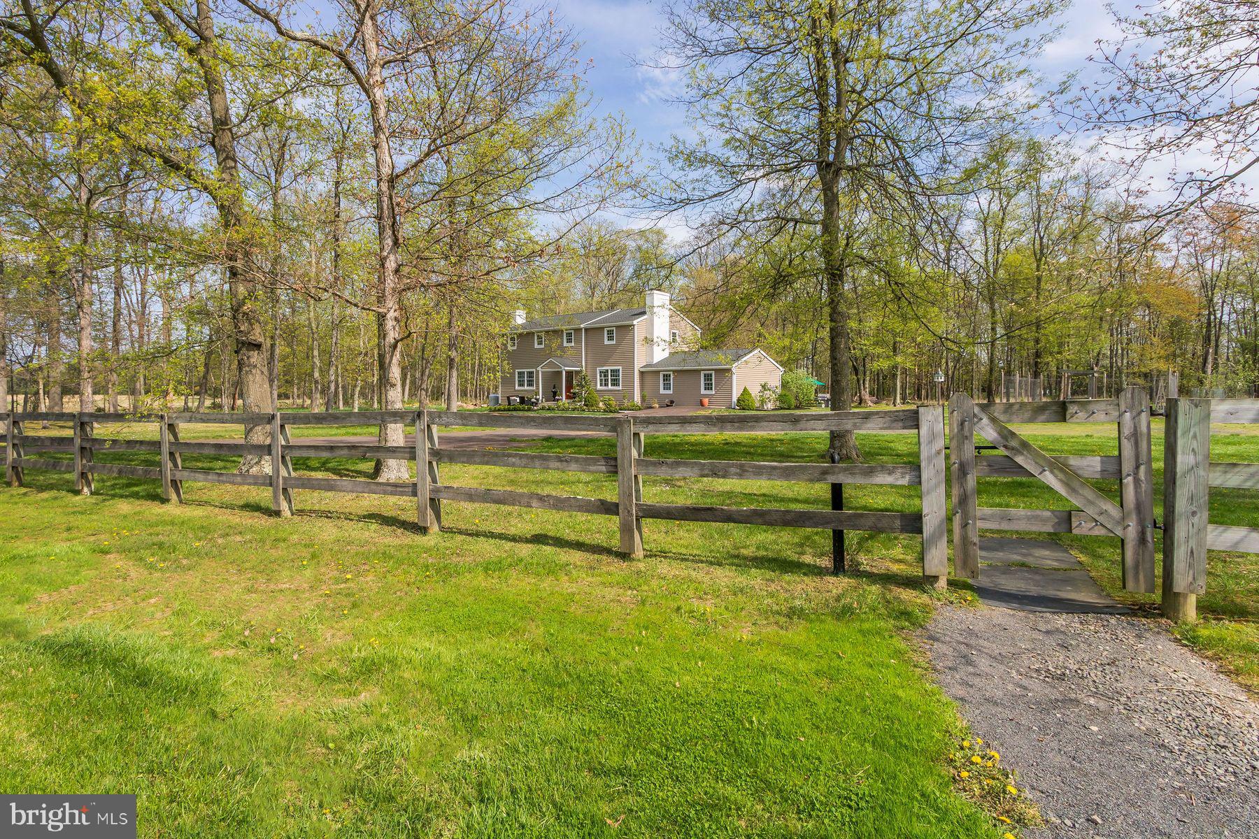 Welcome to Field Day Farm. Just what everyone is looking for. Ten acres with a lovely home, beautiful barn, gorgeous, safe, and new horse fencing in one of the most desirable areas of Bucks County. With easy access to New York City and low taxes. The in-law suite on the first floor opens up many opportunities for the new buyer. Enter through a gated driveway that winds through the open and level ten acres of horse pastures to a nicely updated farmhouse. Built in 1976, the home has 3.5 updated bathrooms and a lovely, well-designed kitchen. The large living room has a wood-burning fireplace with a hand-hewn wood mantel. All of the rooms on the first floor have newly added recessed lighting and gleaming red oak hardwood floors. The large family room has been opened up for easy entertaining with a very special live edge bar made from a long walnut slab which can easily seat 6 people for cocktails or watching the big game. This open up to the kitchen and dining area. The dining area sits surrounded by windows on three sides with a lovely vaulted pine ceiling, alabaster chandelier, tile floor and double glass doors leading to the greenhouse. The greenhouse will make any green thumb owner happy and houses an adorable 1/2 bath. Off the kitchen is an office with another brick wood-burning fireplace with a maple mantel. The upstairs has the original hardwood floors with four large bedrooms. The primary bedroom has a walk in closet and newly updated bathroom with carrera marble floors and a large walk in shower made with more marble tiles. The guest bath is newly updated with tile floor and tile shower. The home has full basement that is partially finished. There is water treatment system and a new hot water system and whole house generator. Attached to the home is lovely one bedroom full bath apartment, just perfect for guests, in-laws or and AirBnb. The home overlooks bucolic, organic fields and trees and is nicely situated near the horse barn. No chemicals or fertilizers have been used on this land. The current owners have built beautiful cedar raised garden beds for easy gardening and surrounded them with deer protection fence. There are 7 well-established apple trees near the welcoming fire pit for late-night chats. The barn, consisting of 11 14x11 stalls, sits close to the pastures and paddocks for easy turn-in and out. Plus, the owner, a knowledgeable and experienced horsewoman, has water and electricity near all the fields for easy watering.
The inside of the barn has been recently stained, sealed, and painted. Each stall features a removable partition, making 14 x 22 stalls perfect for breeding season. The barn features a heated tack room, a hot and cold shower stall with heat lamps, and a large feed room with lots of counter space and storage cabinets. Above is a 70+ foot hay loft with outside loading access. Just outside the barn are 7 Amish-built post and board pastures, 6 with electric and water. In addition there is an 11x31 foot run-in shed/tractor storage with lights/electric. All this is an easy commute to NY City, fine dining, the Delaware River for fishing, Kayaking/canoeing and hiking trails. There have been multiple articles recently explaining why the rich buy farmland. Farmland is a hedge against inflation. Farmland appreciates, acting as a reliable safegard for wealth. Here is your chance in a very special area of Bucks County.