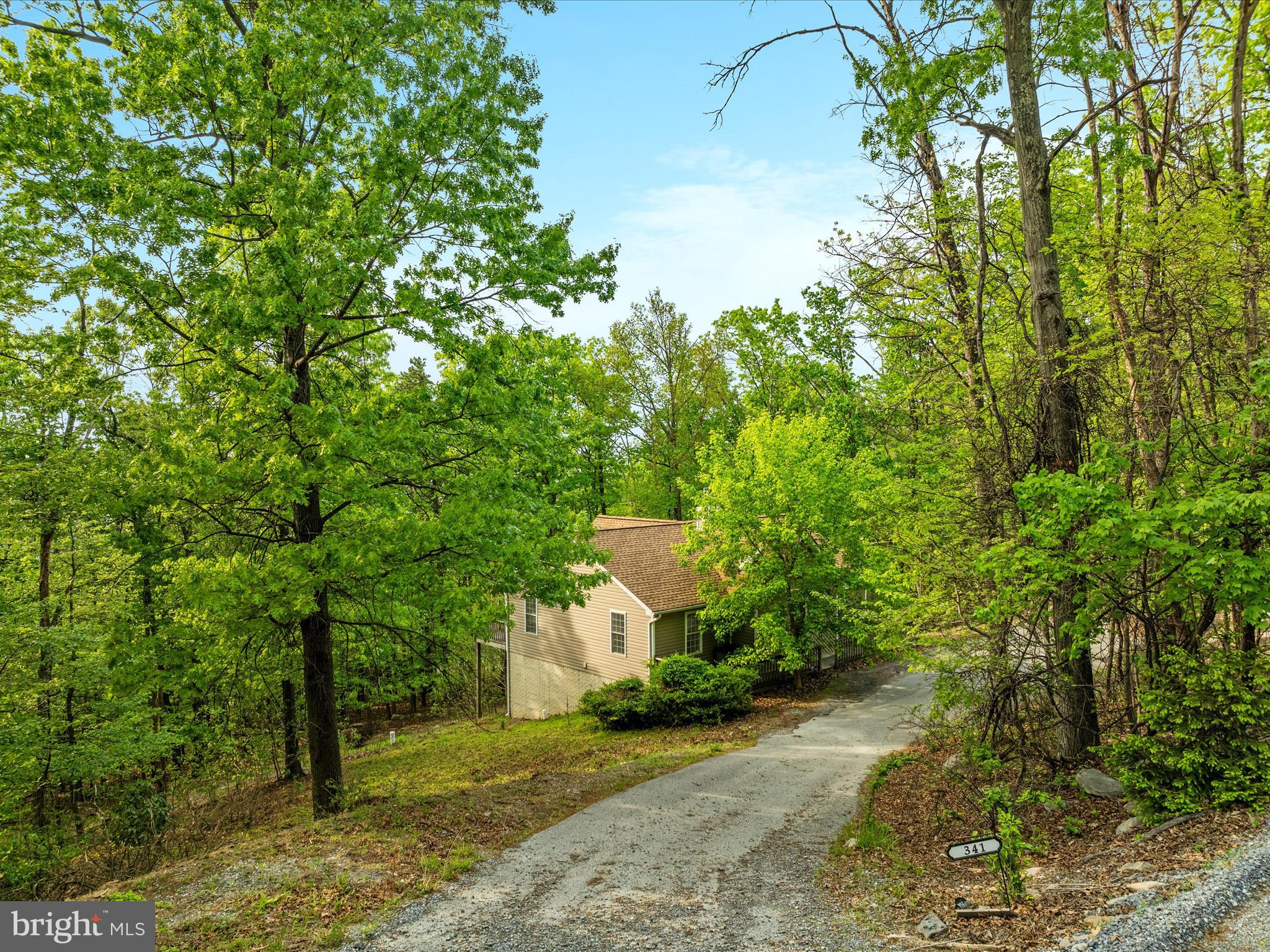 High atop the western slope of the Blue Ridge Mountains, and nestled between the Appalachian Trail and the Shenandoah River is the community of Shannondale. And here, at one of the highest perches of this beautiful spot is 341 Wren Ln. In the wintertime when the trees are bare, the views are, well, “top of the world”. <br><br>
Step inside the open floor plan with vaulted, beamed ceilings and skylights, and an enormous stone woodburning fireplace grounds the space. From there, the floorplan just works. You’ll see. <br><br>
This 2000sf home with 3 bedrooms and 3 full baths has many new touches – the entire main level has new paint and flooring (LVP and carpet) and the kitchen features brand new quartz countertops, sink, faucet and disposal. There is a deck that spans the entire back of the home, where peace and quiet are found 24/7.<br><br>
The lower level has 800 finished square feet, perfect for a rec room, office, exercise area, or even to have a guest space. The full bath in the lower level makes it practical and functional for all of your ideas.<br><br>
No HOA, no “next door neighbors” except the wildlife. <br><br>
This may be your weekend escape from NOVA/DC, or your forever home. It’s spacious enough and designed to work easily either way. So come check it out and fall in love.