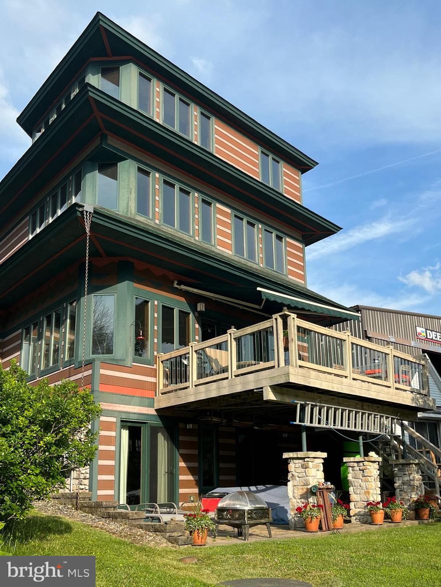 Come visit this Modern Craftsman home located on McHenry Cove with a western view of the Wisp's ski slopes with a type A Dock. This is truly a popular location where one has access to so many activities and events in the area. This home will stand out with it's unique quality craftmanship throughout.  Enjoy the sunset on the west facing deck and it is perfect for stargazing as well.  4 spacious bedrooms with ensuite baths all have amazing lakevies.  A study/den on the first level can be used as a 5th bedroom. 
The first level has a breakfast room off the kitchen - an open living/dining room, den and a full bath (shower). The 2nd level has 2 bedrooms with lakeviews and full baths with spa tubs. There is also an office niche,  the closet in the office has a hook up for a stack washer/dryer.  The third level has the primary bedroom and bath with spa tub - awesome lakeview - plus a storage attic and office niche. The spacious lower level  accommodates the 4th bedroom with ensuite bath, laundry room as well as a recreation room, a separate area could be used as a game room, This level has a walk out to the large patio site prepared for a hot tub.
There are 5 parking spaces in front of the house and an additional 4 spaces in the large parking area adjacent to the driveway (in the large parking area ).  See Easement information in property disclosures.
This home has been used by the owners and has not been on the rental market but an estimate of rental income is available. Rental  projection attached in documents. Agent is co-owner.