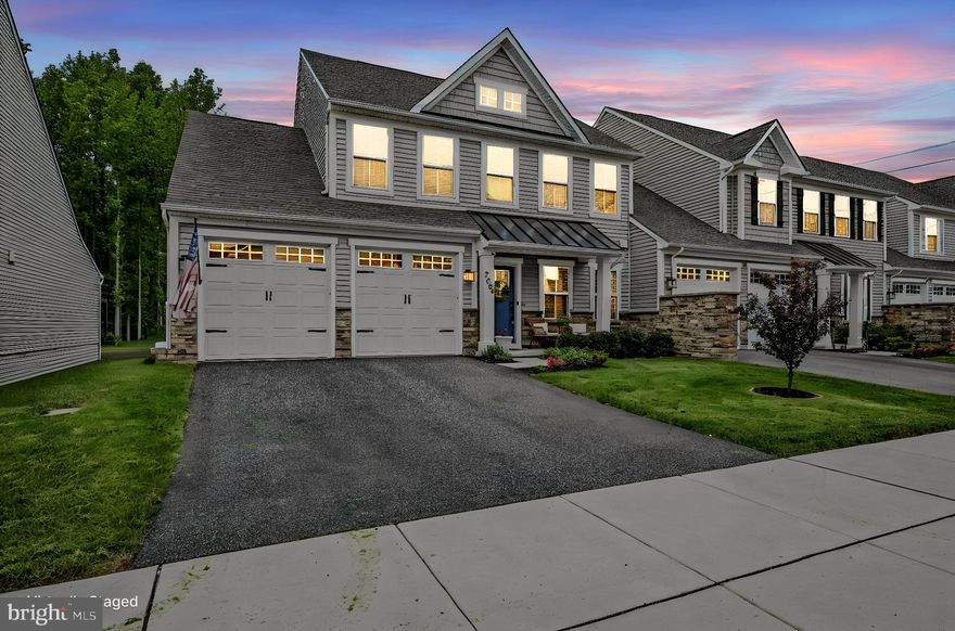From the moment you arrive, this home impresses with beautiful curb appeal, a landscaped yard, covered front porch, and spacious two-car garage. Inside, the thoughtfully designed open floor plan is filled with natural light and enhanced by rich wood flooring that flows throughout the entire main level.
<br><br>
At the heart of the home is a stunning gourmet kitchen designed for both everyday living and entertaining. A massive center island with pendant lighting and bar seating creates the perfect gathering space, while upgraded countertops, subway tile backsplash, stainless steel appliances, and abundant prep space elevate both style and function. The kitchen opens seamlessly to the spacious family room featuring soaring ceilings that create an airy and inviting atmosphere.
<br><br>
Just off the main living area, the morning room extension offers exceptional versatility and can easily serve as a home office, playroom, sitting room, or additional dining space depending on your lifestyle needs.
The main-level primary suite provides a private retreat complete with a tray ceiling, oversized walk-in closet, and luxurious spa-inspired bathroom featuring a double vanity and frameless glass walk-in shower.
<br><br>
Upstairs, a spacious loft with plush carpeting offers the perfect secondary living space for guests, movie nights, or a quiet lounge area. Two additional bedrooms and a full bathroom complete the upper level, providing comfortable accommodations for family and visitors alike.
<br><br>
Outside, the backyard backs to a peaceful wooded area, creating a private natural backdrop with endless potential to design your dream outdoor living space, whether it’s a future patio, firepit area, or garden retreat.
<br><br>
Adding to the ease of everyday living, the HOA includes lawn maintenance services such as grass cutting and fertilization, as well as snow plowing and driveway shoveling during winter weather. Trash service is also included, allowing for a truly low-maintenance lifestyle and more time to simply enjoy your home and community.