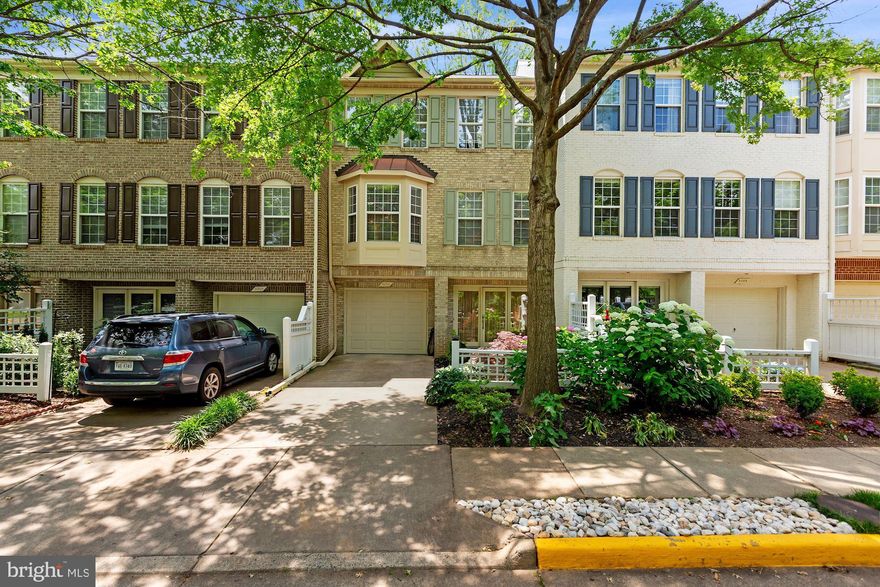 This stunning and lovingly cared for, East-West oriented, Garden Entry Foyer Townhome, filled with natural light from dawn to dusk, is just MEANT for entertaining!  The lush and elegantly landscaped front garden leads the way to the covered front entrance.  Let your guests into the aptly named “Garden Entry Foyer”!  Bright and open, it sets the tone for what is to come!  The artfully curved stairway leads one up to the main entertaining level!  Here, the gracious dining room is flanked by the bright and spacious living room to the left and the open kitchen and family room combination to the right.  The three sided fireplace gives a small separation between the cosy family room and the dining room and the gleaming hardwood floors throughout the space provide the perfect stage for your stylish decor!  Whether your guests are mingling in the living room, hanging out in the family room or gathering around the kitchen island, your activities in the kitchen will not separate you from the fun!  For overflow entertaining space, the rear garden is just the ticket!  Just two steps down from the family room, the generous patio, surrounded by beautifully landscaped beds continues the elegant ambiance!  Once the happy guests have departed, head up the second curved stairway to the bedroom level.  Here you’ll find everything you need to retreat and restore.  The perfectly sized master suite includes a large walk-in closet and spa-like en-suite bath with granite counter and double sinks, private WC, separate shower and wonderful soaking tub with custom blinds for privacy!  The double doors provide access to and from the oversized landing where a second laundry, with stacked full sized front load W/D means your clothes can stay on one floor!!  The two well proportioned front bedrooms and generously sized hall bath are also accessed from the landing.  And for those guests who want to retreat from the party on the main level, the rec-room on the entry level, where afternoon sunlight streams in through the window, can offer some peace and quiet.  A full bathroom and utility room, complete with additional laundry, are also accessed from this room.  Before you leave, don’t forget to take a peek at the immaculate garage!!  And all of this can be found just down the street from Vienna Metro!