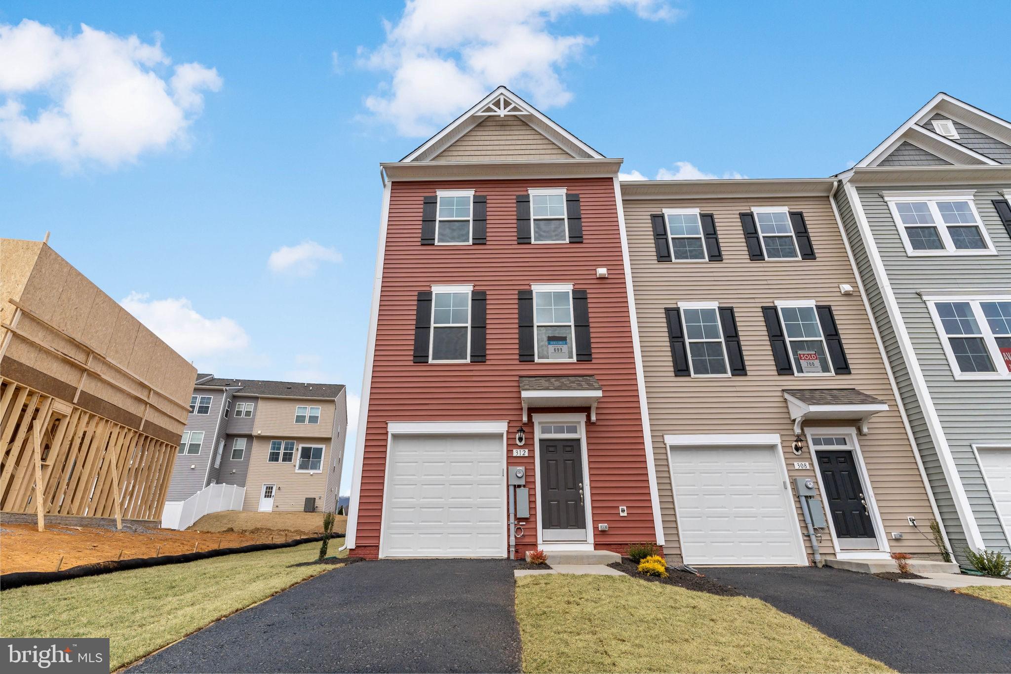 MOVE-IN NOW!***END UNIT WITH A POND VIEW!! *OFFERING UP TO 10K INCENTIVE FOR PRIMARY RESIDENCE WITH USE OF PREFERRED LENDER AND TITLE. CONTACT SALESPERSON/CONSULTANT FOR DETAILS* Come home to Berkeley County’s premier planned community featuring a clubhouse, swimming pools, walking trails, lush landscaping and mountain views. The Darlington II with elevation 3 is a 3 level townhome with 1 car garage featuring 3 Bedrooms and 3.5 Baths. It is fully finished from top to bottom. The front porch leads directly through the front door into the spacious lower level including 9 ft. ceilings, foyer with a double coat closet, and access to the garage. Leading into the fully finished lower level recreation room with full bath and walkout access to rear yard complete with with privacy fencing. This home features a 3 level morning room extension and oak staircases throughout. Open concept main level with 9 ft. ceilings, luxury vinyl plank flooring throughout this main level, dining room. The kitchen has stainless appliances, a large 8’ plus island, upgraded level 2 kitchen cabinets & quartz countertops, that leads directly into living room with powder room. The primary suite includes a large walk-in closet and primary bathroom that includes a vanity, tiled shower and separate soaking tub. Laundry is located on the bedroom level.