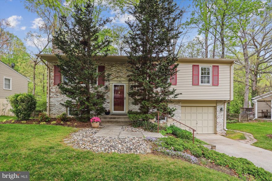 Welcome to one of Prince William County's most desirable communities Lake Ridge. Pride of ownership shows throughout this beautifully maintained former model home featuring 3/4 bedrooms and 3 full baths. Thoughtfully designed and upgraded, this home offers unique touches not found in similar floor plans .  Step into a bright, open 2-story foyer that leads you upstairs to the main living area. A large  Living Room showcases a custom knee wall, architectural column, large widow framed with colonial wood molding trim. The adjacent formal separate Dining Room also accented with colonial trim, offers direct access to the deck- perfect for outdoor dining or relaxing and overlooks a serene, tree-lined backyard. The bright eat-in Kitchen features wood floor and tasteful updates. The main level also includes a private Primary suite with updated bath, 2 additional Bedrooms and  2nd updated Hall Bath. Downstairs you 'll  find a versatile 4TH Bedroom (Closet in Hall) with window, nearby is the updated 3rd full Bath. A cozy , sunlit Rec Room features Brick Fireplace with gas logs (see info in BRIGHT MLS DOCS), a classic wood mantle and a walk-out to the private patio - ideal for entertaining or unwinding.  Location highlights:
Convenient  to commuter services including the VRE. Convenient to all schools, an array of Lake Ridge HOA top notch amenities ( pools, tennis courts, playgrounds, scenic hiking trails, and more). The community features shopping, fitness center, library, Historic Occoquan, and Lake Ridge Marina with golf, boating, fishing, picnic areas, and more.  Enjoy nature as you walk or bike on the trails.      
A wonderful place to call home.