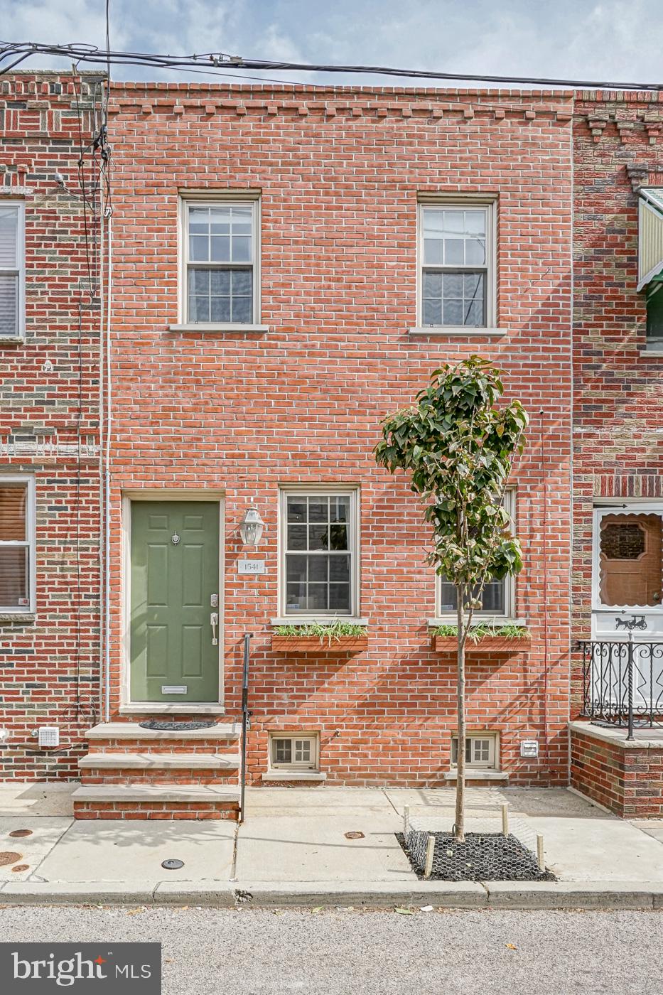 With an unbeatable East Passyunk location, this recently renovated home is move-in ready and absolutely adorable. Close to everything and pleasantly situated on a quiet side street and wide lot, the open layout of the first floor offers the right sized living room, dining room, and kitchen, all complete with beautiful hardwood flooring and charming touches throughout. The kitchen boasts a timeless, classic look complete with white subway tile backsplash, GE stainless steel appliances, granite countertops, and white shaker-style cabinetry. A wood-top kitchen island allows for additional entertaining, prep, and storage space. The large window above the sink coupled with a french door leading to the back patio lets in a wealth of natural light. The patio is perfectly sized, whether enjoying a morning coffee or dining alfresco. Also off of the kitchen, a sliding barn door opens up to reveal the stairwell to the finished basement which also boasts a full bathroom with soaking tub. Don t miss the bonus storage room and laundry area. Head upstairs to find the two bedrooms and a second full bathroom. The master bedroom features a walk-in closet with shelving, a ceiling fan, and receives ample natural light. The second bedroom also has a closet and ceiling fan, in addition to a cozy, built-in window seat with hidden storage beneath. The renovated upstairs bathroom offers a glass walled shower with rain shower head, white tile flooring, and a large vanity for storage. One block from the heart of trendy East Passyunk, a foodie's paradise of restaurants and cafes, and two blocks to the Tasker-Morris Subway station with direct access to the stadiums and Center City, this home is convenient to the best that this vibrant neighborhood has to offer.