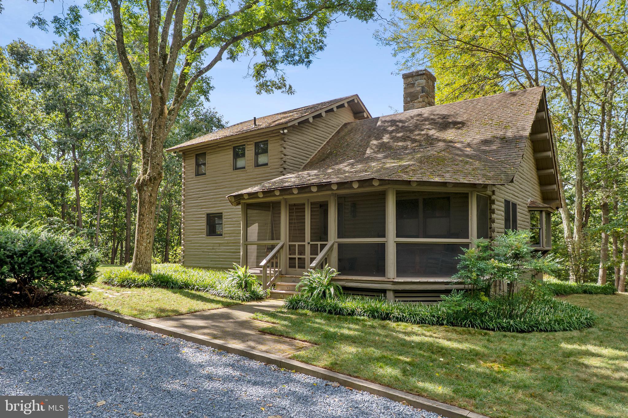 This property is a little slice of heaven. Your own oasis of privacy. You would never know that you are only 5 minutes away from I-270 and 15 minutes away from the Capital Beltway. There are 7.3 acres of mostly treed land with about half an acre of cleared land around the home. Among the trees are 8 fully established American chestnut trees and a professionally landscaped design. This custom-built log home is constructed of white cedar logs making it naturally resistant to insects without any chemicals. Step inside to the gleaming white oak floors throughout the majority of the first floor. Observe the centrally located wood stove backed by stones that was quarried from the Potomac that reaches up to the peak of the cathedral ceiling with lovely uplighting. The owner's suite is located on the second floor with its own private balcony, a walk-in closet and bath. In addition to the living room, dining room and kitchen with an abundance of storage in the custom-made cabinetry, there are also 2 good sized bedrooms on the main level. The lower level is partially finished with a great family room. There is also a walk-out, tons of storage and plenty of room for hobbies like wood working. This home has a very large, screened porch, a balcony and a large freshly stained deck with stairs to the yard. You will never want to leave! And for you work from home individuals, high speed internet is available. There is a permanent creek located in the woods. The seller has marked the corners of the lot for you and there is a plat in the document section of the mls. There are stunning views from every window so you can enjoy the abundant perennials that start blooming in January with the winter blooming Jasmine and proceed through spring and summer, then finish with the wonderful colors of fall. Unique properties like this rarely become available. Don't miss your chance to own private, wooded sanctuary where joy, happiness and bliss abound.