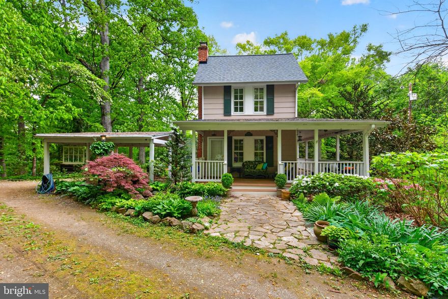 Charming, thoughtfully updated and cared for by the same owner for over 40 years-- this historic residence beautifully blends timeless character with modern comfort. Set on over a half acre, this one-of-a-kind heirloom property, offers 3 bedrooms and 1.5 baths, surrounded by professionally designed gardens filled with native and imported perennials, shrubs, and flowering trees. Towering 200-year-old oak trees anchor the landscape, complemented by beech, spruce, cypress, pawpaw, maple, dogwood, and redbud species—creating a peaceful, park-like setting that attracts birds and butterflies year-round.

Originally part of the estate of Judge Dobbin’s 19th-century home, the property honors its past while embracing modern living. Exterior highlights include an inviting wraparound porch, winding garden paths, a hot tub, a two-car carport just steps from the front door, and a new roof. Inside, the home features a fully renovated eat-in kitchen with updated appliances, rich cherry flooring throughout the main level, refreshed bathrooms, thermal windows, upgraded HVAC with central air, updated electrical and plumbing systems, and fresh paint throughout—offering a move-in-ready home with enduring historic character.

Located in the distinctive Lawyers Hill community—one of Maryland’s earliest planned suburban enclaves dating back to the 1800s—this property is part of the MD/Howard County Historic Register. Lawyers Hill is known for its collection of historic homes built by prominent Baltimore professionals seeking a retreat along the Patapsco River, and today it retains its rare blend of architectural heritage, natural beauty, and quiet charm. The home is within walking and biking distance to Patapsco State Park and offers easy access to I-95, I-195, the BW Parkway, Route 100, BWI Airport, Baltimore, Ellicott City, and Savage Mill.
