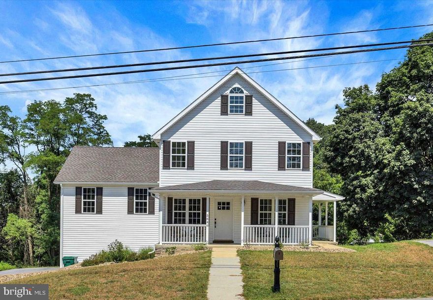 Welcome to this beautifully crafted traditional home with farmhouse charm nestled on a large wood lined lot, offering over 2,248 square feet of thoughtfully designed finished living space. From the moment you arrive, you'll appreciate the inviting covered front porch and the timeless white exterior. Step inside to find an abundance of natural light, high-end finishes, and premium craftsmanship throughout. Home had been ripped down to the studs and new insulation added. The main level boasts a living and dining area with luxury vinyl plank, with the dining room featuring built-in storage/closet—perfect for simple conversion into a first-floor bedroom or office if desired. The upgraded kitchen is a chef’s dream, featuring American Woodwork cabinets, quartz countertops, tile backsplash, under-cabinet lighting, a one-touch faucet, pantry, and eat-in space, with convenient outdoor access. The spacious family room impresses with vaulted ceilings, dual ceiling fans, an electric fireplace, and luxury vinyl floors, creating a warm and inviting space to relax. A full bathroom with a large linen closet completes the main level. Upstairs, the primary suite offers luxury vinyl plank flooring, a walk-in closet with built-ins, and an en-suite bath with a large double vanity. An additional bedroom and full bath provide ample space, while the third level features a versatile spacious third bedroom with heat pump/split system. The unfinished basement is perfect for storage. Oversized two-car basement garage plus plenty of additional parking areas ensure ample space for vehicles. This home has been meticulously upgraded, including: New tankless hot water heater (2024). New roof with lifetime architectural shingles (2025). Top-of-the-line 200+ amp electrical panel. Newer 4-zone heating system (2024). New front door. Upgraded bathrooms. New washer and dryer. Upgraded outlet wiring. All applicable warranties to transfer. Located just minutes from shopping, dining, and entertainment, this exceptional home is the perfect blend of modern convenience and classic charm. A joy to own!