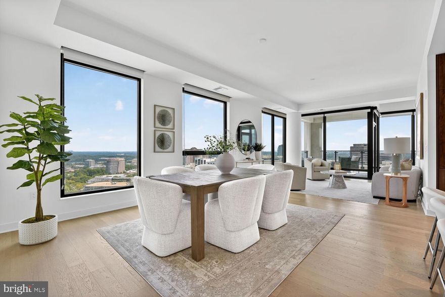 This light filled 2 bedroom + den corner residence on the 19th floor has sweeping unobstructed views of the city from every room. With over 1,800 sf of living space, this unit features interior design by Cecconi Simone with exquisitely designed finishes throughout the spacious residence. The handsome kitchen offers full height custom Italian cabinetry, a large island with seating space, gas cooking and concealed top of the line appliances for a seamless integration of the open floor plan design. The expansive dining room, living room and den have floor to ceiling windows and lead to the large private terrace, a perfect place to entertain or relax. The primary bedroom suite is flooded with natural light and has abundant closet space. The primary bathroom features a large vanity with plenty of storage, LED edge lighting, a spacious frameless glass shower, Calcutta marble and separate water closet. The second bedroom offers a walk-in closet and ensuite bathroom. A powder room and large coat closet are just off the entry foyer. A separate laundry room with built-in shelving and full size washer/dryer is included in the well designed unit. Two garage spaces and an additional storage unit complete this offering. Designed by the award-winning architectural firm, Shalom Baranes, the Verse offers luxurious amenities including 24 hour concierge, grand entertainment lounge, a one acre Skypark with multiple gathering spaces and covered kitchen with gas grills and large bar, high performance fitness studio, pool, guest suites, pet spa and much more. It is located in the Boro, a community of upscale dining and retail shops, cinema and Whole Foods with easy access to the Silver Line Metro. It truly is the perfect place to call home.