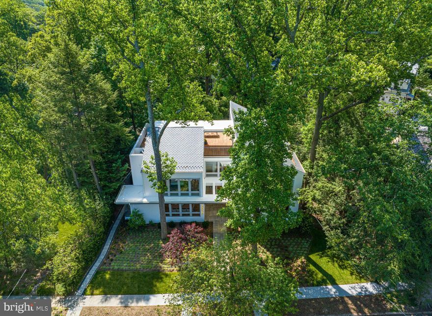 TURN-KEY WITH TREETOP VISTAS! Nestled in the highly coveted Forest Hills neighborhood, an exquisite brand-new gem awaits. 2838 Chesterfield Place, NW is a stunning, modern home built to perfection by Coba Properties, in collaboration with Bennett Frank McCarthy Architects, MS Vicas Interiors, and Joseph Richardson Landscape Architecture. Originally built in the 1950’s, this exceptional residence boasts the entire original footprint with a sleek and elegant modern addition, all crowned with a dramatic new roof line. Sprawling 7,700 SF luxurious living spaces include 6 BRs, 6 FBAs, and 2 HBAs. A large roof deck with treetop views, elevator to all levels, and dramatic scale are a few of the rare amenities in this home. The property's tranquil setting is one of its most alluring features, with beautiful gardens and mature trees on an over ¼ acre lot. The property also features a rear loading two-car garage and driveway.