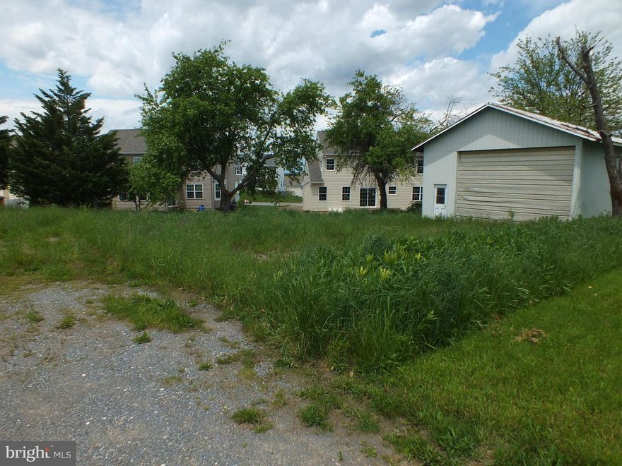 Very nice building lot off a shared drive off Houcksville Rd and close to town. Lots 10,11 & 12 combined are approximately .24 acres. There is a smallish shed on property (27' by 27'). Buyer to check with the city on public water availability and sewer hook-up.