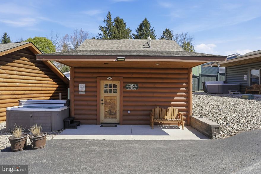 Cabin #3 at The Lodges of Sunset Village is a detached efficiency unit just STEPS to the LAKE with a two queen beds, a sleeper sofa, a kitchenette, a full bath, and approximately 576 square feet, fully furnished and turnkey. This unit has a porch, hot tub and patio, too! It's situated on a premier lot just steps from the lake!

Rich in mountain character and charm, this log cabin features uniquely carved wooden doors, beautiful beamed ceilings, warm wood walls, and inviting spaces that create an authentic lake-and-mountain retreat feel. Additional features include lake and ski slope views, expansive decks, upgraded finishes, open-concept living, a stacked-stone gas fireplace. Enjoy incredible views of Deep Creek Lake and Wisp, along with front row seats for seasonal beauty and memorable moments, including views of the annual July 4th fireworks. 

This property has a proven rental history, generating an average of $42,692  in annual gross
rental income creating an exciting opportunity for
buyers seeking both personal enjoyment and investment potential. Experience one of Deep Creek Lake’s
newest ownership opportunities at The Lodges at Sunset Village. For the first time ever, fully furnished lake
area cabins are being offered for individual ownership in a breathtaking community featuring incredible lake
and Wisp ski slope views. Community amenities include lake access with 10 shared dock slips and an
impressive 1,320 square foot waterfront dock area perfect for fishing, swimming, launching kayaks,
relaxing by the water, and enjoying summer fun at the lake. Residents and guests also enjoy a lakeside
gazebo, playground, fire pit, gathering areas, pet-friendly accommodations, abundant parking, and on-site
professional management. The monthly condo fee provides exceptional convenience, including most
utilities, snow removal, trash service, and yard maintenance, for a low-maintenance ownership experience. Whether you're searching for a vacation retreat, income-producing investment, or both, The Lodges at
Sunset Village offers a rare opportunity to own at Deep Creek Lake. Stop by our on-site Sales Center at The Lodges Gatehouse during open hours to learn more, explore ownership opportunities, and get your questions answered: Thursdays 2:00–6:00 PM, Fridays 1:00–5:00 PM, Saturdays 10:00 AM–5:00 PM, and Sundays 10:00 AM–2:00 PM or call today for details and your private showing!