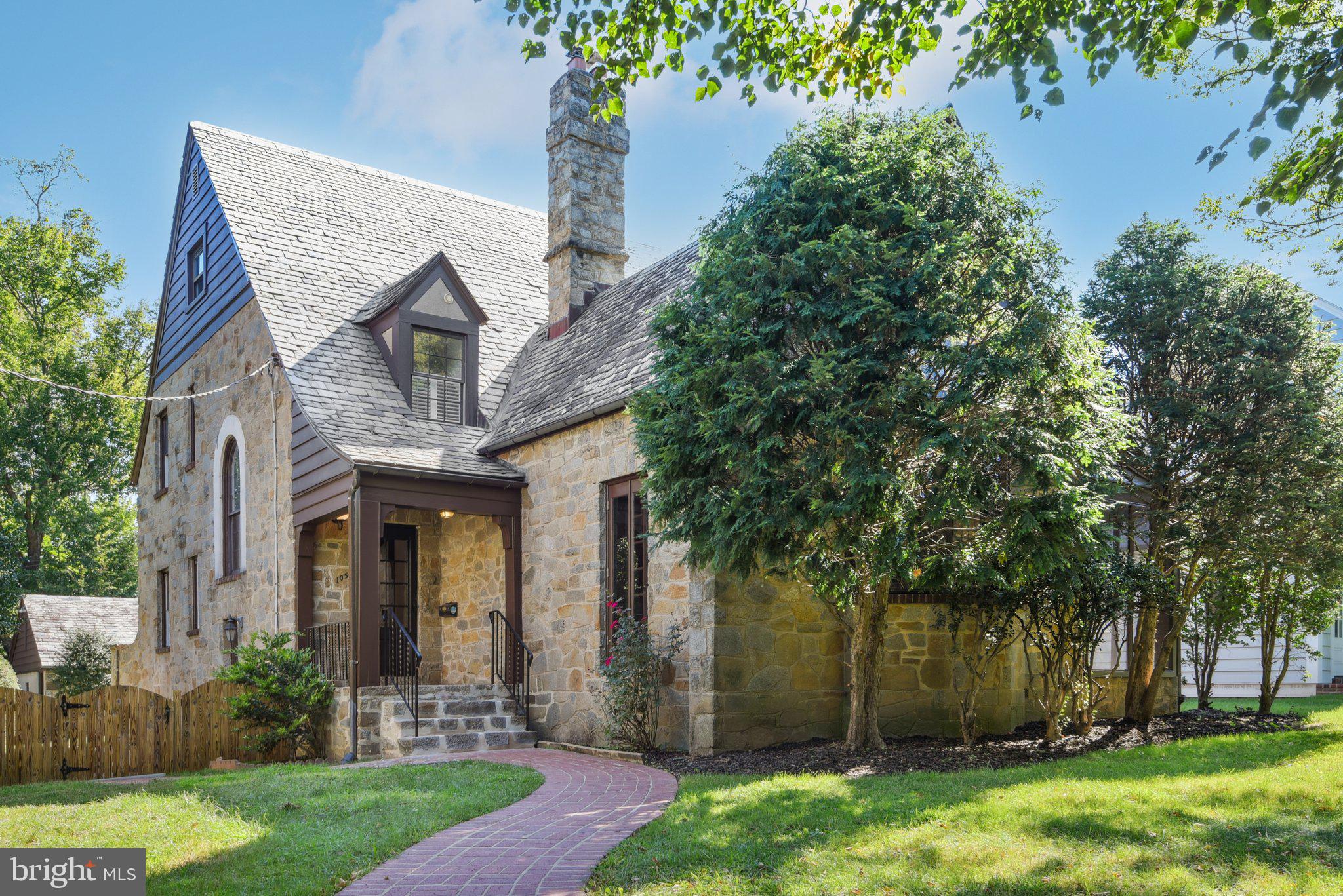 Welcome home to this fabulous 1930's Cottage Revival stone Tudor in historic Chevy Chase Village. A charming, well-built storybook home, it has design features exceeding typical homes of this age. The welcoming and dramatic two story entry has the soft detail of rounded doorways paired with a Palladian window, rounded staircase with wrought iron railings. Step into the large living featuring a high, beamed tray ceiling, bay window & floor to ceiling stone wood burning fireplace. It is bold, yet rustic and welcoming. Multiple French doors open to the good-sized screened porch with vaulted wood ceiling. Enjoy relaxing on the screened porch overlooking the lush green space. The formal dining room leads to an open & updated kitchen with breakfast bar & breakfast room. The kitchen has a 5 burner gas cooktop, recessed lighting, pantry, and walk-out to the rear yard. There is an adjoining full bath. The upper level features the primary suite with two cedar closets, ceiling fan and adjoining full bath. The sun-filled bathroom has a walk-in shower, pedestal sink and checkered tile floor. There are 2 additional bedrooms & a hall full bath on this level. Steps lead to the fully finished attic space. It provides a sitting area and 4th bedroom/office, along with gleaming hardwood floors. A large lower level has the laundry room & storage. There is a rough-in for a toilet. The home has 2 zone A/C, replacement windows, original radiators, gorgeous hardwood floors, incredible arched doorways, interior stone details, stucco walls, a beautiful landscaped yard, 2-car garage parking with extra storage, copper gutters, and a slate roof are just a few of the great features. The natural warming and welcoming construction offer a rare and quaint home, built to last and quick access to DC! One of only 720 properties in exceptional and historic Chevy Chase Village, snatch this rare find before it's gone!