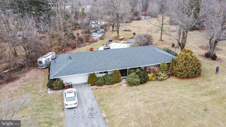 PRICE REDUCTION!  
Your Private Protected Outdoor Paradise Awaits! 
Welcome to this unique Midcentury [1961] stone California ranch house with 80’ of glass sliders and windows overlooking the breathtaking pool patio boasting an authentic Esther Williams concrete pool and covered lanai and preserved 1961 elements with modern amenities.  The concrete pool has been meticulously kept up so you don't have to spend 10k on a new liner!  This back yard pool/patio is Ideal for family get togethers and for entertaining.
The centerpiece of this open plan living/dining/den/kitchen space is a massive brick fireplace, while a second stone fireplace in den ready to go as well.  In the cold winter months they make the home warm and cozy on their own.  This is an original floor plan with three bedrooms: First is an owners suite with private bath.  Then you have two bedrooms connected by Jack & Jill bathroom. Enjoy this home's Period lighting giving your that charm and getaway retreat ambiance.   There is a huge Chef’s kitchen with a 6 burner Viking stove/double ovens, wine fridge, and quartz countertops, new roof and hot water heater.

Your new home sits directly across the street from Concodell Golf Course & clubhouse.  Whether you work from home, or come home from a long day on the road or in the office, you can look forward to relaxing without distractions with just under 4 acres of flat lawn mostly bordered by woods with easements for complete privacy, creek frontage and two ponds.  There is a bridge to your “private island” [see drone photos] great for setting up a picnic or for the kids to romp around and explore!   

There is a pool house, pond house, and a recently expanded large boathouse.  The glass back wall provides huge viewing screen for birds and animals; including deer, otters, foxes, rabbits, chipmunks, turkeys, wild geese, herons, woodpeckers, and raptors.  Show off to  your company the variety of fish and turtles in the creeks and ponds ON your property.   While having creeks, streams, ponds, and woods, unlike most properties, there is ALSO a huge lawn ideal for yard games from cornhole to croquet or as a driving range.  You can really crank up the entertainment with the Fire circle with a fire around the large pond & second fire ‘chimney’ on island.

Located just off the historic Lincoln Highway within 4 miles of Route 81 with easy access to DC, Baltimore, and Harrisburg.  Grocery stores within 3 miles. 25 minutes to historic Gettysburg.  Possible use as AirBnB with proximity to Shippensburg University, Gettysburg College, Penn State Mont Alto, Wilson College, Totem Pole Playhouse, and Caledonia State Park.  This is a must see to experience the full effect!