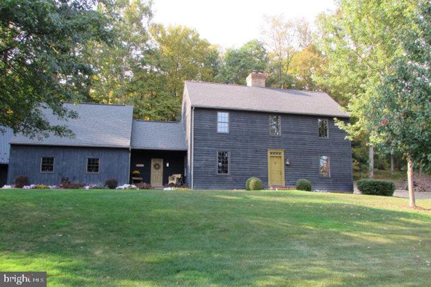 Quaint saltbox home with many custom features including wide plank pine floors, hand crafted hardware,kitchen cabinetry and bath vanities. This 3 bedroom, 2.5 bath home recalls colonial times with the open fireplace in keeping room, formal dining rm and parlor, and shuttered windows. Designed to be livable for a contemporary owner, the home has a finished basement, attached two car garage and separate 3 car garage, workshop area and walk-up bonus room. Situated in a quiet neighborhood, you will be proud to own this home. Call for a showing!