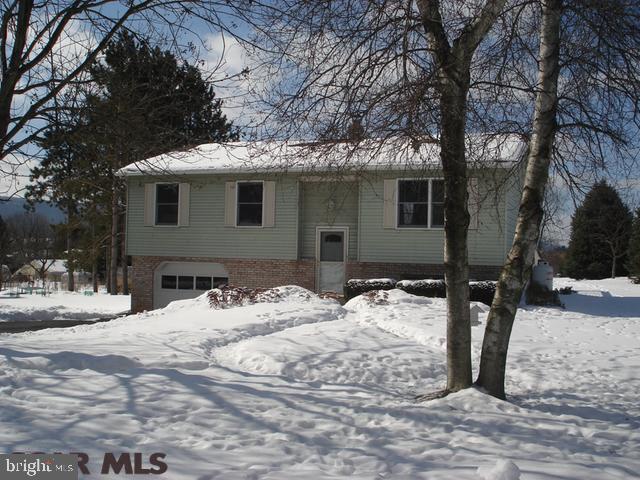 Enjoy coming home to this charming split entry home. The spacious updated kitchen with tile backsplash and newer appliances opens to the bright and cheery dining room. 3 bedrooms, 1.5 bathrooms, laminate wood floors throughout the main level. Cozy up in the lower level family room with wood burning stove or spend your summers evenings on the spacious 11x18 deck. Large corner lot, 1 car garage with workshop area and outdoor shed compliment this delightful home.