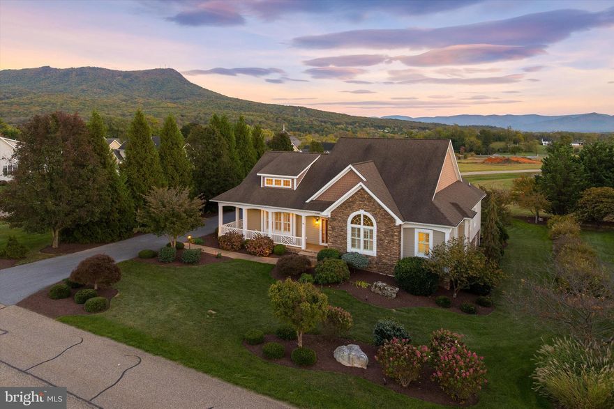 This home is something to talk about - an impressive showcase.  Not only does the curb appeal stop traffic, the beautifully manicured landscape, the handsome stone accents, and the timeless Southern Living/Craftsman charm of a custom-built signature home will sing your tune. The alfresco living captures a glorious mountain view from hidden indoor/outdoor screen porch, coverd veranda, wrap-around decking. A prime location and champion seat on #5 fairway of Lakeview mountain course. All adding to the pleasure and enjoyment of the interior and awesome floor plan. The quality is evident: true hardwood, soaring ceilings, stone fireplace, special moldings accent the open-concept great room, dining, and culinary center, built-in shoe storage room. Spa-inspired first floor primary suite, grand Palladian window, boudoir/hers/his/theirs walk-in closets. Two additional first-floor bedrooms also provide stunning view. The extreme lower walk-out level adds family/theatre/media room, built-in shelving, sequestered office/billards/game room, optional 4th bedroom suite and plethora of storage. Three car oversized garage, privacy greenspace surround, installed lighting feature, and plenty off street parking. The envy of this fabulous neighborhood.