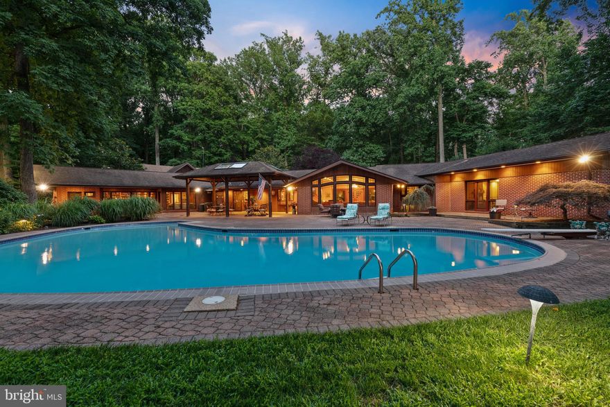 Now available in Velvet Valley is this stunning contemporary home situated on 2.08 acres with an inground swimming pool, tennis court, and Koi Pond. This home has recently been extensively remodeled and includes seven bedrooms and six full and one-half bathrooms. New configurations, newly remodeled kitchen, and five fully remodeled bathrooms. New electrical and plumbing work has been done. The entire home has been freshly painted, including new flooring, lighting, and carpet. Be ready to be amazed at the size and scope of this home. With a left and right wing, this home is perfect for multi-generational living and any size family. The home boasts a three-car garage, an inground pool, and a fenced-in tennis court that has just been resurfaced and includes a basketball net. The remodeled kitchen features two Sub-Zero refrigerators, two dishwashers, a gas cooktop, Brazilian hardwood floors, a kitchen island, quartz countertops, separate built-in cabinetry with an attached granite island, and a new large pantry.  As you enter the home after crossing the Koi Pond, you will step into the living room that has been completely remodeled. The living room has large architectural windows facing the home's rear, allowing plenty of natural light. Brazillian Cherry hardwood throughout. The formal dining room has a trayed, lighted, domed ceiling and a wood-burning fireplace in an all-stone wall. The remodeled great room with a wet bar can be used as a library, office, or family room. A newly installed half bathroom and laundry room are off of the library. The upstairs of the home has been reconfigured and remodeled to include two bedrooms, each with newly remodeled attached bathrooms. Walk-in closets and skylights in each bedroom. Completing the right wing of the home on the lower level is a very large bedroom with a newly remodeled attached full bathroom. The home's left wing has four bedrooms, including the primary suite, a hall bathroom, and a bedroom with an attached full bath and a second laundry room next to the primary bedroom. The primary bedroom has been remodeled, including built-in cabinetry, a gas fireplace with new fireplace surround, a walk-in closet, and a stunning fully remodeled bathroom. Leading from the primary bedroom is a private workout gym room, office, or solarium nestled in nature. This room has central heat and air and includes all operational windows to allow for natural air. On the outside of the home, you have a giant circular driveway with two parking pads, allowing plenty of guest parking. The rear of the home features a large inground swimming pool, a gazebo, a party pavilion, and extensive hardscape landscaping. Competed with a fully fenced-in tennis court and three sheds. The home has two owned buried propane tanks, two septic systems, five zoned heating and cooling, and two hot water heaters. New blue stone in the front of the home, high voltage outdoor lighting and the home is in a cul-de-sac. This is truly a must-see home!