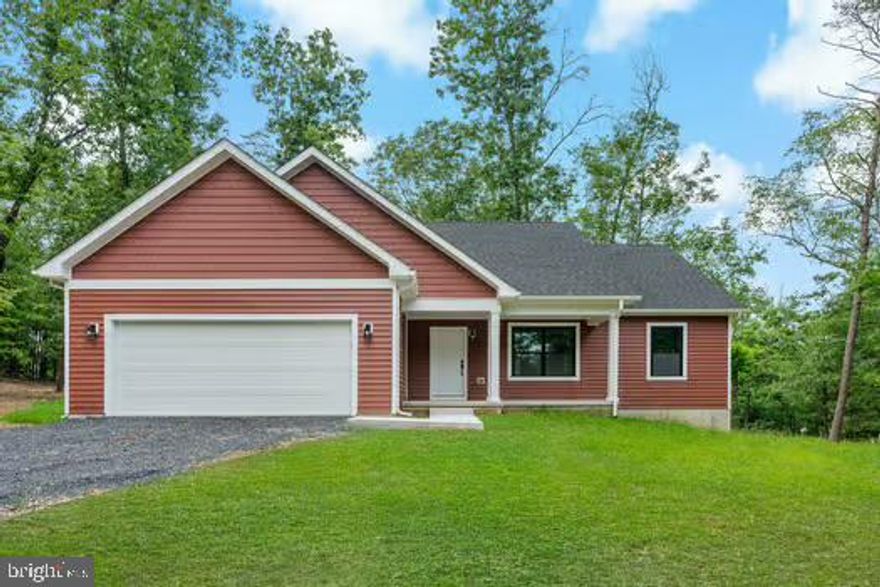 READY NOW! *** REDUCED*** Welcome to this beautiful 3-bedroom, 2-bathroom ranch-style home, nestled on 2 wooded acres in a peaceful neighborhood . This stunning new construction features a welcoming front porch, perfect for relaxing and enjoying the serene surroundings. The open-concept living area boasts luxury vinyl plank (LVP) flooring throughout the main level, providing a modern and low-maintenance feel. The spacious kitchen is equipped with sleek stainless steel appliances and elegant granite countertops, ideal for cooking and entertaining. The primary suite, where you'll find a huge walk-in tile shower in the bathroom. The two additional bedrooms are generously sized and carpeted for comfort. Outside, you'll appreciate the privacy provided by the wooded lot, with some acreage cleared for your outdoor activities. The 2-car garage offers ample space for your vehicles and storage, while the crawl space provides additional room for storage needs. This home is on a well and septic system, adding to its privacy and rural charm, while being surrounded by other beautiful homes in a lovely, spread-out neighborhood. Sidewalk just completed . Don’t miss the opportunity to make this stunning home yours!