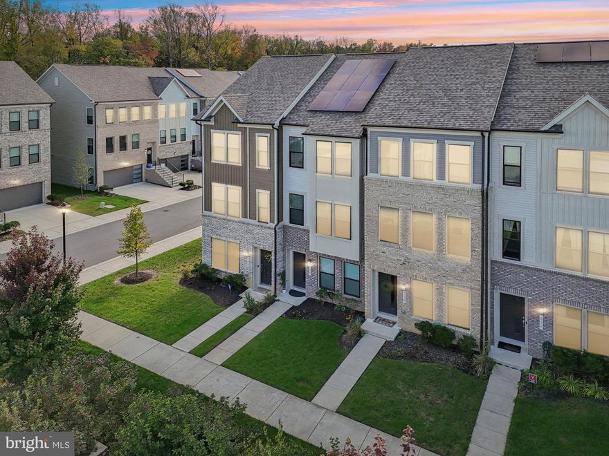 Welcome to the exclusive Watershed community!
This beautiful brick townhome offers 3 bedrooms, 3.5 baths, and an attached garage.

The entry level features a guest bedroom with a full bathroom—perfect for visitors or a private home office. The main level boasts an open-concept great room with a chef’s kitchen featuring gleaming white cabinetry, an expansive quartz island, and a dining area that opens to a spacious deck—ideal for entertaining and complete with a Bluetooth/Wi-Fi–enabled outdoor sound system. This level also includes a dedicated living area and a convenient half bath.

Upstairs, you’ll find the luxurious primary suite and a third bedroom and third full bathroom. A full-size washer and dryer complete the upper level.

The original owner invested over $25,000 in builder upgrades and recently added new carpet (2025), fresh touch-up paint and accent walls (2025), and leased solar panels for an energy-efficient home. The property is also equipped with Guardian Protection home security, including an exterior camera and smart doorbell. This home has been meticulously maintained.

Watershed offers resort-style amenities designed for comfort, connection, and recreation:
• Relaxing lounge pool with sun deck and six-lane competition pool
• State-of-the-art fitness center and yoga studio
• Sports simulator and co-working space
• Community garden, playground, and flex lawn for gatherings
• Outdoor terrace with fire pit and grilling stations
• Dog park
• Miles of scenic trails for walking, running, and biking

Living at Watershed isn’t just about owning a home—it’s about embracing a lifestyle. Perfectly located just minutes from Fort Meade, shopping, dining, and major routes 198 and 32 , this home combines luxury, convenience, and community.