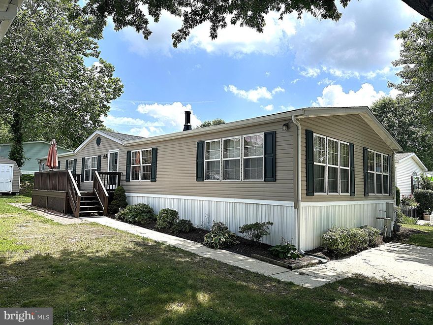 Spacious Double Wide in Sought After Severn Mobile Home Park! Over 2000 Square Feet of Finished Living Space Including a Large Kitchen with Plenty of Cabinets, Counterspace, Island, a Beautiful Wall of Windows Behind the Kitchen Sink and a Breakfast Area. Just off of the Kitchen you have a Big Family Room Featuring a Stone Gas Fireplace. At the other end of the Kitchen is a Separate Formal Living Room with Custom Crown Molding Leading to a Large Primary Suite with a Private Bath, Garden Soaking Tub, Separate Shower and Huge Walkin Closet. The 2nd and 3rd Bedrooms are Nice Sized with Walikin Closets as well and the Hall Bath has a Double Walkin Shower, This Former Model Home sits on a Nicely Landscaped Lot and has a Custom Sundeck with a Rear Lift, Secure Storage Shed and Two Car Driveway. Recent Updates Include Luxury Vinyl Plank Flooring in the Primary Bathroom, Carpet, AC Unit and Roof. Close to Schools, Parks, Shopping, Restaurants, Ft Meade and MARC Train Station.