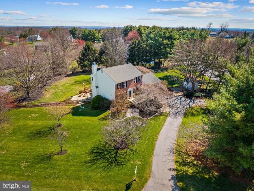 Set on a private flat one-acre corner lot lined by trees in the coveted Four Seasons neighborhood, this beautifully maintained brick-front Colonial offers timeless charm, generous living spaces, and a backyard designed for unforgettable summer nights. A long private driveway leads to a two-car garage and a welcoming front entry with a storm door.  Inside, a bright foyer opens to a classic layout with a formal sitting room or home office to the left and a formal dining room to the right. Down the hall past the powder room, the home opens to the main living and entertaining space. The updated gourmet kitchen (2012) features abundant custom cabinetry, granite countertops, SS appliances, and a spacious eat-in area that comfortably fits a table for six. The kitchen flows seamlessly into the inviting family room, complete with a stone-accented wood-burning fireplace, custom built-ins with backlighting, and sliding doors to the expansive rear deck. Upstairs are four generously sized bedrooms and two full baths. The spacious primary suite includes a walk-in closet and a beautifully updated primary bath (2022). The finished lower level offers a second entertainment area with warm solid pine paneling reminiscent of a cozy ski chalet, a wet bar, and a third full bath, plus a large unfinished area with built-in shelving and workshop space. Outside, the backyard is truly the star of the show. Enjoy the large deck off the main level (refinished w/ new steps and landing in 2025), a walk-out concrete patio from the basement, and a flat fenced yard perfect for gatherings, play, and relaxing evenings by the fire. Lovingly cared for by its original owners and meticulously maintained, this special home is ready for its next chapter. 

Pertinent Details: No HOA, Central Vac System (Equipment to convey), Roof (2018), Water Heater (2025), High Efficiency Heat Pump w/ Regular Maintenance (2010), Pressurizing Tank (2019), Well Pump (2017), Reverse Osmosis Drinking System with 5 Gallon Reserve (2025), Whole Home Water Softener & Neutralizer (2022), Septic Pumped (2024), Refinished Deck (2025), Primary Bathroom Reno (2022), Kitchen Reno (2012), Garage Doors (2023), Front Door (2021), Rear Sliding Doors (2015).