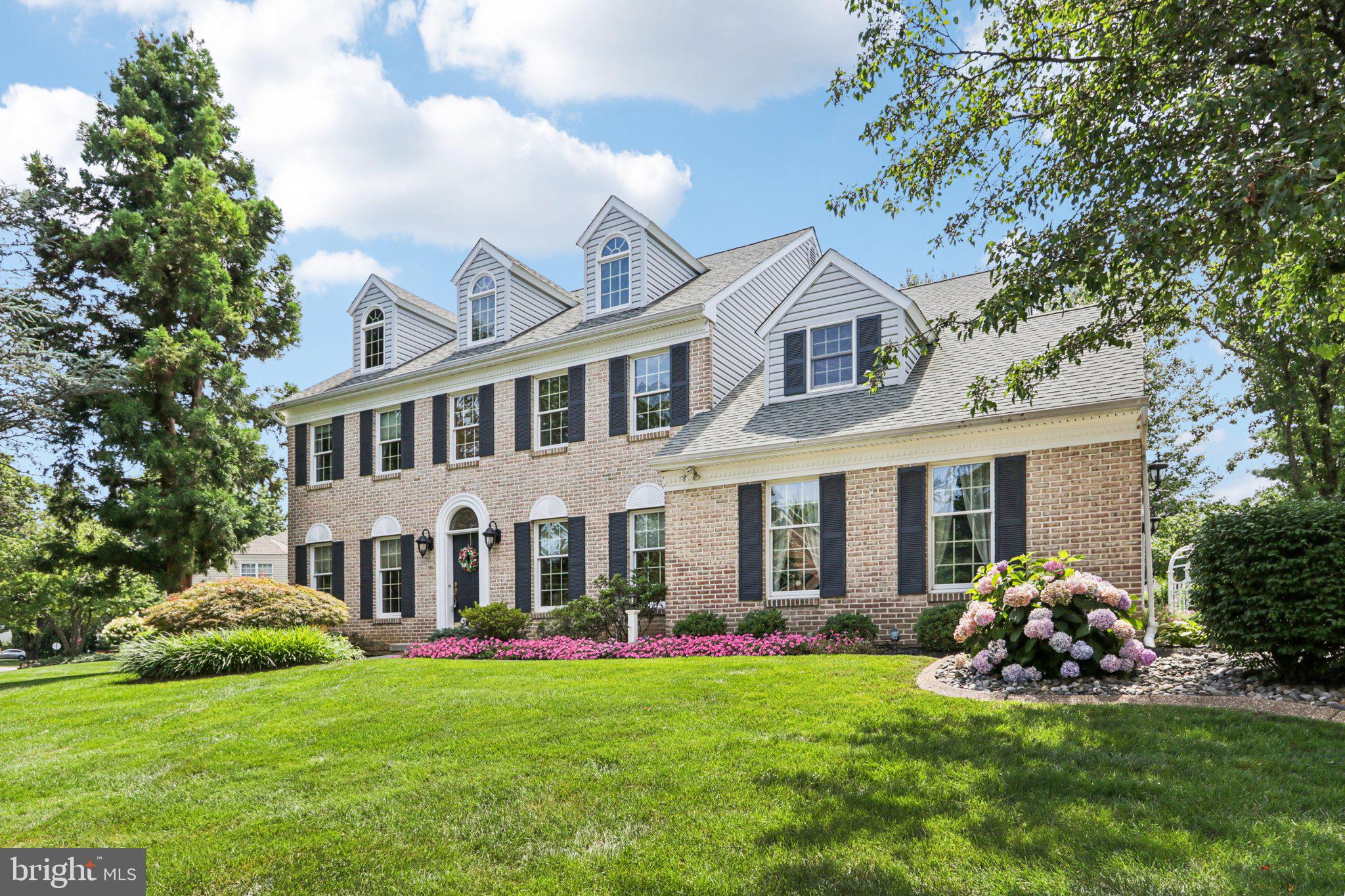 Located in Brandywine Village and East Penn School District, this brick-front home combines timeless charm with everyday comfort. Just a short walk to the elementary school, the peaked roofline and classic windows invite seasonal candlelight displays. Inside, a bright two-story foyer opens to a formal dining room and a versatile living room or den. French doors lead to a spacious great room with gas brick fireplace, flowing into the eat in kitchen with a center island, under-cabinet lighting, Corian countertops, gas cooking, and a built-in desk or coffee bar. The adjacent three-season room opens to a rear patio and yard with an in-ground electric pet fence—ideal for entertaining or relaxing. A hallway-style mudroom with garage and backyard access includes laundry behind closet doors and a full tiled bath with ADA-compliant seamless shower and vanity. Upstairs, the expansive primary suite offers a sitting area, spa-like bath, and walk-in closet. Three additional bedrooms share a full bath with dual sinks. The finished lower level includes a festive bar area, rec room, and two large storage rooms. Freshly painted and carpets cleaned—this home is ready for immediate move-in. Open House: Saturday, July 26 from 10 AM–1 PM