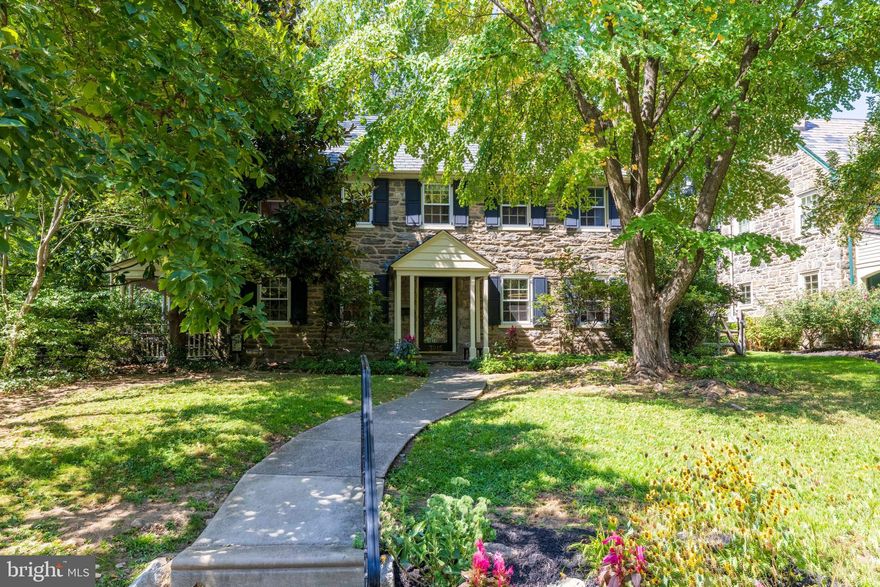 Extraordinary Wissahickon Schist Colonial Across from McMichael Park.   
This stately Center Hall Colonial offers timeless character, generous living space, and an unbeatable location in East Falls. Beautiful oak floors flow throughout, greeting you upon entry.   The spacious living room spans the full depth of the home, filled with natural light from three exposures and anchored by a handsome gas fireplace. Across the hall, the formal dining room features chair rail, abundant windows, and a new chandelier. The bright, modern kitchen opens to a comfortable family room and breakfast nook, complete with granite counter tops, double wall ovens, stainless steel cooktop, dishwasher, disposal, and breakfast bar. A convenient powder room is tucked behind the dining nook. The Steinway Grand Piano in the family room is available for sale.   From the side mudroom, enjoy easy access to the fenced patio and covered porch—perfect for entertaining or relaxing. This side yard also includes the driveway and attached garage, while a second, expansive fenced backyard behind the garage offers endless gardening or play space amid mature specimen trees and shrubs.   Upstairs, you’ll find four generously sized bedrooms, including a spacious primary suite that spans the entire side of the house with windows on three exposures and an ensuite bath. Each additional bedroom is bright with windows on two sides, and one serves as a walk-through room. A full, floored attic with built-in storage and brand-new central A/C equipment provides exceptional storage or expansion possibilities.   The finished lower level adds even more flexible living space, along with abundant storage. Freshly painted throughout, this home blends original details—woodwork, floors, and deep windowsills—with thoughtful updates for modern living.   Set directly across from McMichael Park playground, the home enjoys serene views and walkable access to Midvale Train Station, East Falls’ shops and restaurants, Jefferson University, Penn Charter, and just minutes to Center City.