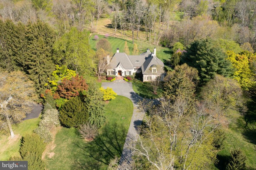 Nestled in the heart of Chester County sits "Fox Hill Farm", a French Country Classic design presiding on a breathtaking 3-acre lot. This masterpiece, built by custom builder Porter Construction, is unparalleled in its use of expert workmanship and the finest materials. Exceptional detail throughout, the highlights of which include arched doorways & windows, a barrel-ceilinged back foyer with herringbone flooring, custom built-ins, and extensive moldings and 10ft ceilings on the main and upper level. The home offers over 5,000 square feet of gracious living, including a great room with masonry fireplace and built-ins, a den with fireplace and family room addition well-appointed with four walls of custom built-ins, masonry fireplace, hand -scraped wood flooring, volume beamed ceiling, and adjacent breezeway with brick flooring and custom wet bar. The chef's kitchen features custom wood cabinetry, commercial grade appliances, center island, and a separate breakfast room. Completing the first floor is an indulgent primary suite with a custom walk-in closet and primary bath with marble tile, dual head shower and Jacuzzi tub. On the upper level is a bedroom suite with a private bath, sitting area (possible fourth bedroom) and finished storage. The grounds are artfully designed with terraces, beautiful landscaped gardens, and full irrigation; all of which provides an ideal backdrop for entertaining. This property is ideally located within close proximity to area shops, restaurants, and the arts. Further highlights include a fully fenced yard, whole house generator, water detection, geothermal heating and full house foam insulation, four zone heating and cooling, on-demand water heaters, entertainment system, extensive landscape lighting, Superior wall foundation, and a Lutron lighting system in the addition.