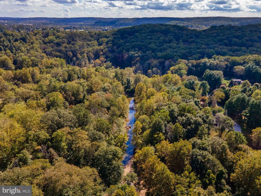 AGENT AND CUSTOMER MUST SIGN AND RETURN TO BROKER THE ATTACHED HOLD HARMLESS PRIOR TO VISITING THE PROPERTY. NO ONE IS ALLOWED TO ENTER ANY OF THE STRUCTURES.  THEY ARE NOT SAFE.  Live authentically. Experience the bliss of living on the Western Run river. Panoramic long vistas running north and south. Teaming with wild life. A bird watching bonanza. Let the sounds of the river lull you to sleep at night and wake to a glorious sunrise glistening on the water every morning. Two contiguous parcels each with the potential to build a main house. Pricing reflects one building right. Buyer to confirm. Sculpt your vision. Create living sculpture. The larger parcel can serve as your own wildlife sanctuary for hiking and communing with nature or if you decide to obtain a perc and well, it could beckon for an interesting house built into the hillside with commanding views of the river below. The smaller parcel has more useable rolling land that gentle slopes to the rivers edge. A once in a life time opportunity for this incredible river frontage. One of the longest stretches I have ever seen. So close to Hunt Valley and yet a world away. A magnificent setting. Majestic rock outcroppings and a trail network in place. Hike in your own back yard. Your private park. Bring your Architect and make it real. The art of uniting human and home. Cultivate your existence.