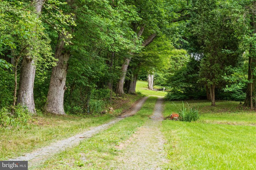 If you have been searching for a private Farmette property surrounded by unimaginable beauty, lush trees and wildlife - this is the property for you ! Brook Valley Farm is nestled on 2.4 acres surrounded by mature trees, fresh water streams and rich landscape.  Extraordinary value in the heart of Montgomery County’s agriculture reserve.  A rare opportunity and unrivaled rural oasis just minutes away to major urban amenities, i270 and Clarksburg.

As your enter Brook Valley Farm you'll see an old farm house through the trees; it's a bumpy lane, so go slow. The grass is called "cottage grass" and is redolent of the old days, with springtime violets, clover, and summertime wild strawberries. No pesticides have been used on any of the land. You drive over the small stream. It's the spot where deer cross over each night, going from the larger stream on your right, over to the small stream and up into the hills where they'll rest until morning. If you sit on the porch as the light fades, you can watch the skittish deer cross the yard in their daily ritual.

What was originally a log cabin back in 1830 saw some "improvements" in the early 1900's. The original beams, cut on site and still supporting the sleeping loft, are doing their job well. The kitchen affords space for a table and chairs and three garden windows were put in to provide additional space to start seeds or place some houseplants. 

The 1909 "improvements" added a wrap around space referred to as the Victorian addition. It provided a downstairs parlor with fireplace, a staircase to an upstairs small bedroom and larger primary bedroom. The addition connected the cabin loft space and added sleeping porches. These were enclosed when water was brought into the house in 1953 and the porches were transformed into two dressing rooms with closets and vanities, ending in one shared bath. Downstairs, another bathroom, laundry room and additional room (office) were added. The kitchen was updated in 2005, downstairs bath in 2014 and upstairs bath in 2023. Both bathrooms are accessible with low threshold showers.

The outbuildings and pool deck were probably added in the late 1960's or 1970's. A new liner and automatic cover were updated in 2004-5. The old chicken house was convenient to store umbrellas and chairs; the old smokehouse is the home of the pool filter and storage shed. 

One owner was affiliated with the National Arboretum and loved to bring plant cuttings and trees out to the farm. More fond of a palette of green to a more colorful one, you still see the results in the wide variety of the green shades of spring and summer, the vibrant red of a driveway maple, and the cedar that towers over the side door of the house. Many willows and curly willows follow the course of the stream to the West of the house. The property is occasionally visited by a heron who does indeed act as if he owns the place. Every Spring there are geese who are sure that this is a good place for their nest. Tree frogs are wonderfully loud each Spring as they confirm the change of seasons and Summer brings out the fireflies. 

Brook Valley Farm is close to The Comus Inn for a special night out or a fabulous brunch spot (2.5 miles), Sugarloaf Mountain Vineyard (4 miles) with it's events, and about 11 miles from Monocacy National Battlefield to the Northeast. There's more to discover in this area as you wander the byways.