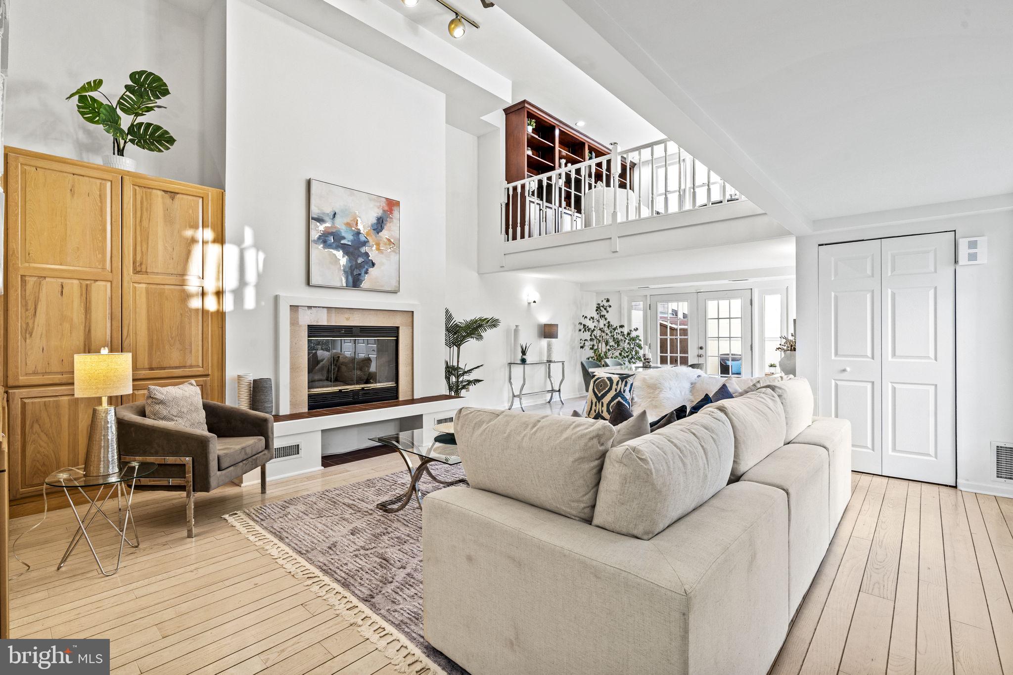 Located in the heart of Washington Square West within the desirable French Village Community, this sun lit home has 3 large bedrooms, 2.5-baths, garage parking, three outdoor spaces and offers urban convenience with an open, airy interior. Natural light flows through the expansive, multi-level first floor layout, where soaring ceilings, an elegant staircase, and wide-plank hardwood floors add warmth and sophistication. The open-concept living areas create an effortless flow, anchored by a sleek fireplace with built-in cabinetry. From the living area, you have access to the first-level patio and the community courtyard, ideal spots for unwinding or entertaining. There is a half bath located on this level as well. The separate dining area connects seamlessly to an inviting eat-in kitchen featuring ample cabinetry, a built-in dining table, and a serving station, blending style with utility. A large loft overlooks the main living and dining areas, making it an ideal space for a home office, library, or quiet retreat.
On the second level there are two generously sized split bedrooms. One of the bedrooms opens onto the second level balcony, overlooking the courtyard. This floor includes a full bathroom with a washer and dryer, as well as a well proportioned storage room.
The third level is a luxurious primary suite, thoughtfully designed as a serene personal haven. A large sitting area with a fireplace opens onto a spacious deck, perfect for enjoying morning coffee or enjoying city views. The spa-like primary bath features dual vanities, shower, and a jetted soaking tub, completing the suite with an extra touch of indulgence. The wonderful primary bedroom features high ceilings and provides an ideal space to unwind after a long day.
This fabulous home is a stone's throw away from the area's top hospitals, theaters and restaurants. This residence also provides easy access to public transportation and quick routes to major highways, including 676 and I-95. Covered garage parking adds to the convenience and peace of mind. Perfect for those seeking space and comfort, this residence offers the perfect blend of style and convenience in one of Philadelphia’s most vibrant neighborhoods.