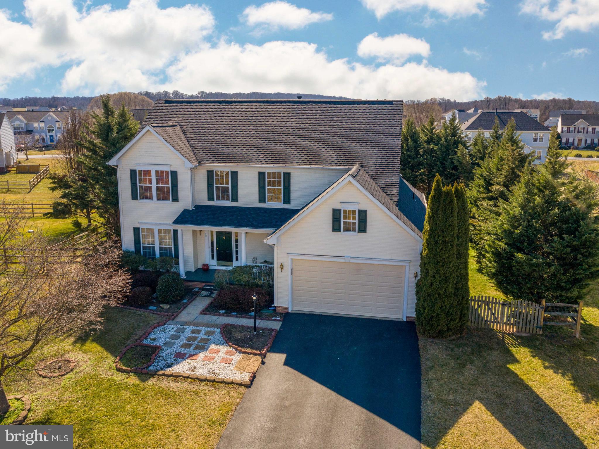 Large colonial on Locust Hill golf course with a fenced, treed back yard, full sunroom bump out and lots of room to spread out. Wave to the neighbors from the covered front porch, hang out in the backyard with a playset, or simply sit in front of the fireplace and relax. The open floor plan, with additional formal living room and formal dining room, gives the whole family lots of room on the main level. The large master suite upstairs features a large ensuite bath with soaking tub and shower and a huge master bedroom. The unfinished basement also has a rough-in for an additional full bathroom. **new roof in 2018** All close to commuter routes 340, 9 and 7 to Northern VA and MD.