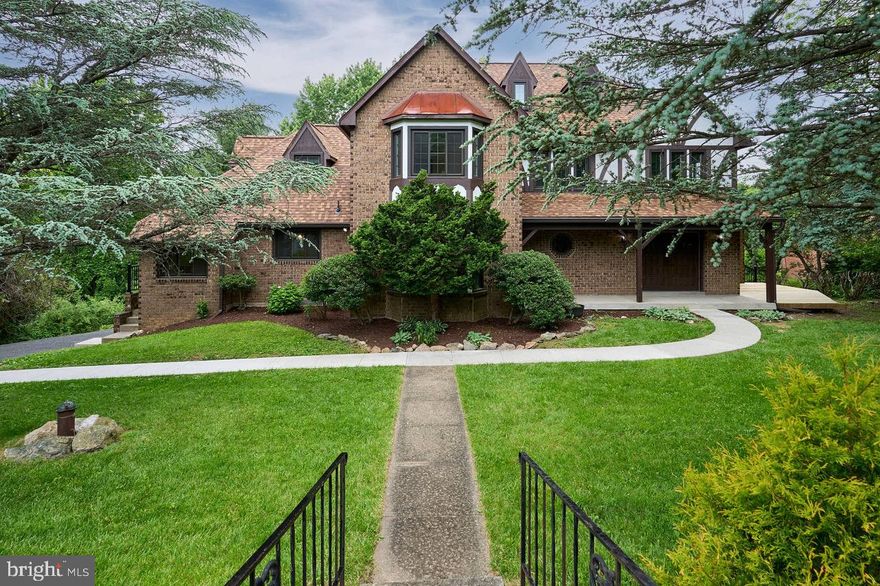 Back on the market - buyers' financing fell through offering you an exciting opportunity to take a second look! The motivated sellers' reduced pricing allows the new owner to add their personal touch whether through modern updates or by enhancing the classic characteristics of its English Tutor flair. 

This grand residence is a timeless gem in the desirable Round Hill neighborhood. Offering 5 spacious bedrooms and 4.5 well-appointed bathrooms, the home spans a total of 5,384 finished SF with exception to the large 2-car garage. Thoughtfully upgraded over the past two years, it combines historic elegance with today’s conveniences.

Inside, you'll find a layout designed for both comfort and function including a convenient main-level bedroom and full bath, perfect for guests or flexible use. A refined butler’s pantry adds a touch of classic charm, ideal for entertaining. Like the warmth of the sun without a draft, comfortable heat is provided by durable ceiling radiant heat system - elements are embedded in the ceiling. Each room has its own thermostat, allowing you to control temperatures room by room. 

The kitchen is designed for the cooking enthusiast, featuring an induction cooktop, convection oven, and cork flooring that’s gentle underfoot and forgiving to dropped dishes. Bathrooms have been updated with modern finishes, and the primary bathroom features a luxurious 70-gallon soaking tub that offers spa-like relaxation at home.

Significant updates include new windows, a new roof, new deck and walkway, new garage doors, a 90-gallon water heater, new pressure tank, new basement flooring, and new washer, dryer, and refrigerator.   For added peace of mind, smoke and Co2 detectors have been replaced, along with new side door and basement double entrance doors.

Set on a fully fenced, meticulously landscaped lot, the property also features a small animal run and storage sheds, perfect for owners who appreciate both function and beauty in their outdoor space. The rear yard expands beyond the split rail fencing, providing even more room to enjoy.

Don't miss your chance to make this distinctive property your own! No HOA and no city tax.