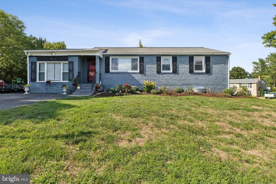 Welcome to 6604 Woodley Rd, a charming two-story brick ranch in the desirable Clinton Estates neighborhood. This inviting home features 6 spacious bedrooms—3 on the main floor and 3 in the lower level—ideal for family gatherings and entertaining. The bright, airy layout enhances the generous living and dining areas, creating a warm and comfortable atmosphere. Elegant hardwood floors, stylish crown molding, and recessed lighting flow into the eat-in kitchen, which offers ample storage and a cozy nook for family meals. A standout feature is the walkout basement, which includes a 2nd full kitchen, full bath, washer and dryer, and 3 additional bedrooms, all leading to a lovely backyard perfect for gatherings and grilling. The backyard features a concrete patio, providing an excellent space for relaxation and outdoor enjoyment. Ample parking is available with a private driveway on a spacious half-acre corner lot. This home's prime location is just a short distance from shopping centers, entertainment, and public transportation, offering the charm and convenience of this exceptional property.