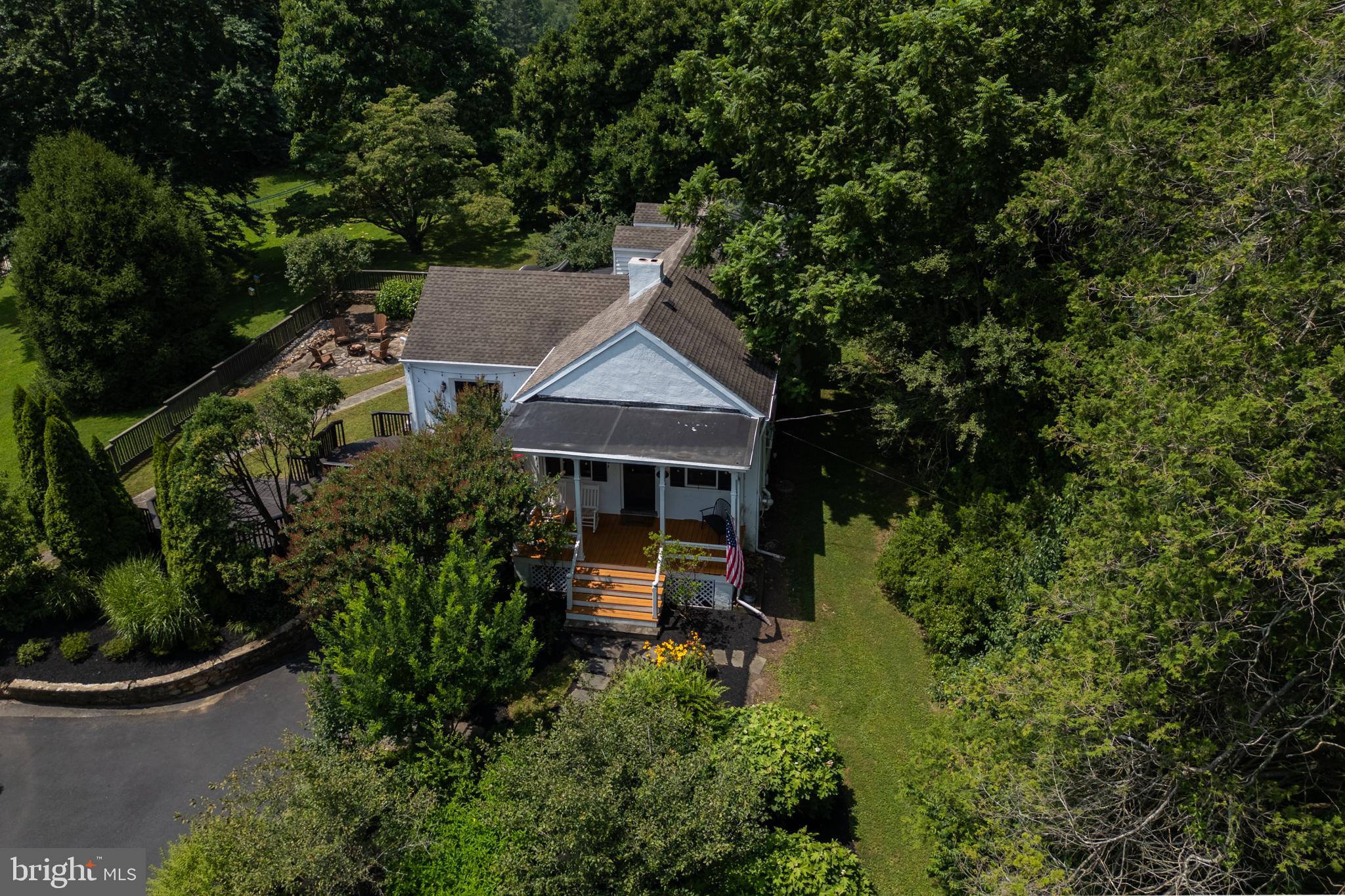 Incredibly unique and simply stunning! 617 Unionville Rd is one of those rare gems, jam packed with character, and offering amazing indoor and outdoor living spaces - all in the highly rated Unionville-Chadds Ford School District. This yard is so compelling – with a covered front porch, multi-tiered deck and stone patio – you may not want to go inside, but once you do, the home is so charismatic, bright and inviting that you might not want to go back out! In a stunning blend of old-world charm and chic design, you’ll step into a front parlor with the inviting vibes of a British pub, complete with a wood burning fireplace and a bar with 3 stools. As fun as it would be to spend the day in the parlor, the rest of the house has so much to offer. There is a beautifully styled modern kitchen and bathrooms, a dedicated dining room, a living room with another wood burning fireplace that features a magnificent stone hearth, and there’s a spacious, light-filled sunroom with a skylight and built-in bench. This home has 4 bedrooms and 3 full bathrooms, but in another unique twist, 2 bedrooms and 2 full bathrooms are located on the main floor, including the owner’s retreat with a walk-in closet and en suite bathroom. The 2nd bedroom shares its closet space with the washer, dryer, and could make a wonderful home office if you don’t need to use it as a bedroom. Upstairs, the 2 bedrooms and full bathroom are just as charming as the rest of the home, with A-frame roof lines, neutral carpeting in the bedrooms and nice natural light. A home for all seasons – in spring, you’ll be wowed by the blooms on the giant “teacup” magnolia tree, in summer and autumn you’ll be surrounded by lush, wooded landscaping in your private outdoor oasis, and in winter you can enjoy the views and watch the snowfall from the sunroom which includes an electric fireplace. The backyard also features a gigantic shed which is wired with electric and is fitted with workbenches. To top it off, 617 Unionville Rd is situated just minutes from the heart of Kennett Square, minutes from Longwood Gardens, and you’ll enjoy convenient access to Rte 1. Truly a must-see home! Request a personal tour today!