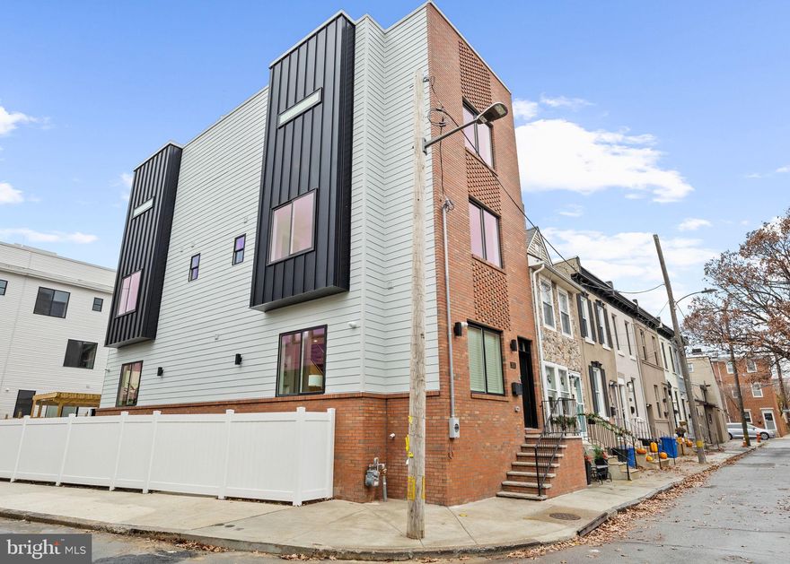 Experience next-level luxury living in this brand new Fishtown masterpiece. This architecturally striking townhome with 4200 square feet of living space,  rare two car parking, and within the coveted Adaire school catchment dont come arround very often.  Step inside to a dramatic first floor where the dining area flows into a showstopping chef’s kitchen featuring vaulted ceilings, high-end appliances, double oven, wine fridge, waterfall island, premium designer finishes, and a statement chandelier suspended from the second story is the kitchens focal point. The rear living room delivers a true cinematic vibe with its fireplace, stunning tiled feature wall with custom surround shelving, and coffered ceilings with cove lighting.  One of the home’s standout features is the extra-large, professionally landscaped rear and side backyard. Thanks to its unique lot shape, the rear opens to an impressive 36 feet of width, offering a rare amount of outdoor space in the city plus two car driveway parking for unmatched convenience. The second level hosts two spacious bedrooms, each with its own en-suite bath, along with a hallway laundry room and linen closet. The entire third floor serves as a your luxury primary retreat, complete with two walk-in closets, an expansive bedroom with an fireplace and built-in shelving with LED lighting, overhead & pendant lighting  and a spa-inspired bath with a extra large walk-in shower, large soaking tub and double vanity. A flexible bonus room on this level makes the perfect home office, nursery, or dressing suite. The fully finished basement adds even more versatility with an entertainment room, a fourth bedroom, and a full bathroom, ideal for guests or extended living. Tech-forward features include a security system with exterior cameras and a Bluetooth-integrated audio system with speakers throughout. A top-floor wet bar with an additional beverage fridge leads to your private roof deck with sweeping skyline views, the ultimate backdrop for morning coffee or sunset gatherings. 10 year tax abatement and 1 year builders warranty included. A residence crafted with this level of scale, design, and intention is more than a home it's a statement piece for modern Fishtown living.