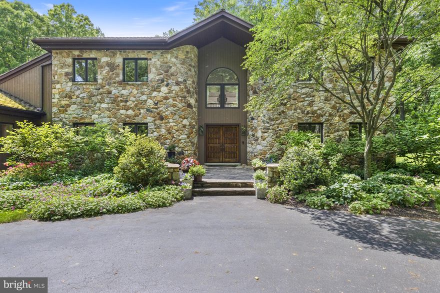 This pristine lot is just less than 14 acres and sits set back off the road in the private Pentland community in Centreville. The expansive property affords sweeping views of Brandywine Valley countryside. Enjoy all the seasons from the thoughtfully placed windows throughout the home as well as the large Ipe deck (new in 2021) on the rear of the house. Follow the tree-lined drive to this stunning contemporary stone home. Access the front of the house via the circle driveway or go to the left of the house to access the 3-car garage. Enter the front via stately stone steps into an open-air foyer where you get an immediate sense of the uniqueness of this home. To the right find the formal living room with gas fireplace. Continue down a private hall past a full bath and large closet to a private study with curved wall of windows. To the left of the foyer is the formal dining room. A swinging door leads to the updated kitchen with functional island and an abundance of custom cabinetry, cooking amenities, space for full table seating, and view of front garden. Attached to the kitchen is an additional office/butler’s pantry, laundry room and half bath, elevator, mudroom with mop basin and access to the garage. Returning to the foyer entrance, continue straight back to the large two-story great room which is the heart of this home. Adding ambiance to this impressive room is the open-air curved staircase as well as the two-story wall of windows bathing the room in natural light. Sliding doors open to the deck. The striking floor-to-ceiling stone fireplace adds to the cozy, relaxed atmosphere of this gathering place. Between kitchen and great room is a conservatory, perfect for houseplants or over-wintering tender outdoor plants. Beyond the family room is a game room with full bar, powder room, lounge area and sunroom overlooking the rolling hills beyond. Use either of two staircases to go to the second floor. Find the primary suite with fireplace, small hallway with mirrored doors hiding extensive storage, his/her walk-in closet, dressing room and large combination bathroom, laundry, and sitting area with radiant floor heating. Two additional bedrooms share a Jack-and-Jill bath, and two more bedrooms share a hall bath. An unfinished lower level provides plenty of storage options. At the edge of the lot is a detached “two-car plus” heated garage (with water) that can house maintenance equipment and other tools. The outdoor deck overlooks a luxurious pool surrounded by a paver patio. Mature trees provide privacy and shade. A sloped lot provides unsurpassed views of the surroundings as well as the stocked pond below the hillside meadow. Enjoy the serenity of this private oasis while still having proximity to Centreville, Greenville, Wilmington, Philadelphia and all that the area has to offer. Pentland is ten minutes from Longwood Gardens, Winterthur Museum and Gardens, Brandywine River Museum and Mt. Cuba Center.