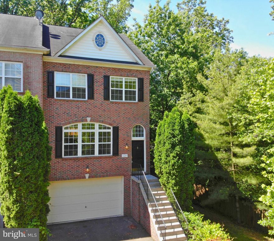 Drop Dead Gorgeous! -  End Unit  with 2 car garage - Oversized Townhome - BEST Premium Lot in Fair Chase, Backing to trees, woods, privacy. Like new condition loaded with upgrades - 3 or 4 Bedrooms, 3. 5 baths.. Large open kitchen w/ high end SS Appliances, granite counters and beautiful cherry cabinets.  Hardwood floors on the main level, Brand new plush carpet on the upper and lower levels...Whole house freshly painted neutral modern white. 3 generous size bedrooms upstairs, including large owner's BR with walk-in closet, luxury bath and lots of natural sunlight.  The finished lower level includes brand  new carpet, a full bath, gas fireplace and level walkout to private fenced yard, and newly refinished deck backing to trees! Super close to great schools and shopping including Wegmans, Costco, Home Depot, and Fairfax Corner. Seconds from major transportation, I66, Fairfax County Pkwy., Routes 50 and 29.  Lovely neighborhood with delightful community pool and clubhouse.. Don't lose out, so Hurry to this amazing home!