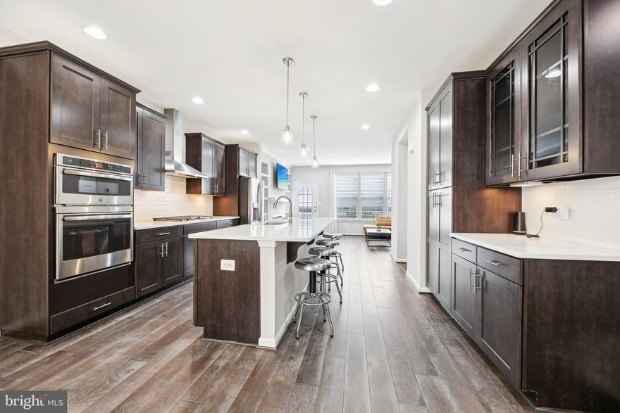 Here’s your chance to own this Impressive, rarely available 4 LEVEL townhome with a Prime Location in the sought-after Hampden neighborhood. Features 4 bedrooms, 3.5 baths, open layout, recessed lighting, Gourmet Kitchen with upgraded stainless steel appliances, built-in oven and cooktop, extra large range hood, double deep farm sink, tile backsplash, plenty of cabinetry and aa huge center island with breakfast bar. The open concept floorplan is great for entertaining! The living room features a beautiful accent wall with built in gas fireplace and custom shelving. The trex deck off of the living room is the perfect spot to unwind after a long day. The main level bedroom and adjacent bathroom is perfect for guest and privacy. The upper level boasts 3 spacious bedrooms including the primary suite with private bathroom. Head up to the 4th level where you’ll find a Bonus Loft space that leads out to the Expansive Wrap Around Rooftop Deck! Enjoy amazing city views including the downtown Baltimore 4th of July fireworks display. Parking is a breeze with your 2 car garage Plus 2 car parking pad! This convenient location is close to all of the Hampden restaurants and shops! Nothing to do here but move in and enjoy. Welcome home!