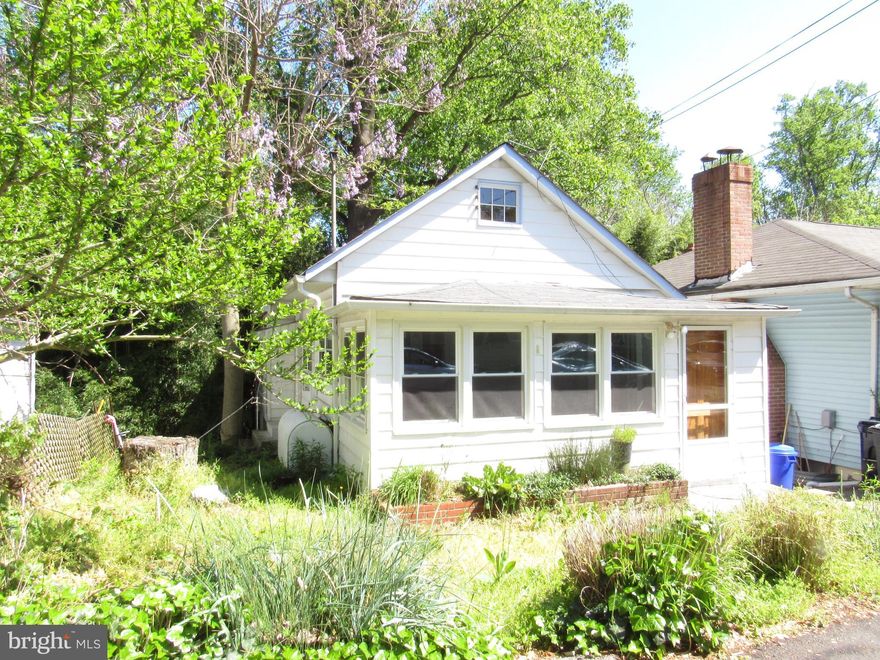 BACK ON MARKET...Cute beach bungalow just steps from Chesapeake Bay  Boardwalk.   Home nestled in among greenery that keeps it cool in the summer months.  Enter the home into the finished porch that could be a nice sitting room or art studio.  The main living space has knotty pine walls that adds to the ambiance of this home.  Kitchen in a long galley kitchen with breakfast bar and small pantry.  This would be a great renovation project to update. The bath features a tub/shower combination plus a dual flush commode.. There are two bedrooms on the main level.  Access to the unfinished basement is from both sides of the home  on the lower level.  Finish off this basement and you will have more living space.  It has windows already.  Laundry set up is on this level. This home has been owned by the same family for years and was used as a rental property. If you are an investor, you can get 1000-1200 a month rent.  Close to shopping, library, water park, boardwalk, restaurants and beach activities.  Oil Tank is Owned.    PROPERTY IS BEING SOLD AS IS  Location drawing JUST COMPLETED  by  Advanced Surveys.  Lower Level can not be entered from main house.  Large open space for you to design the space yourself.    You will enjoy living in the land of pleasant living...Chesapeake Beach. HOME IS BEING SOLD AS-IS. .  THANK YOU  CONVENTIONAL OR CASH OFFERS ONLY
