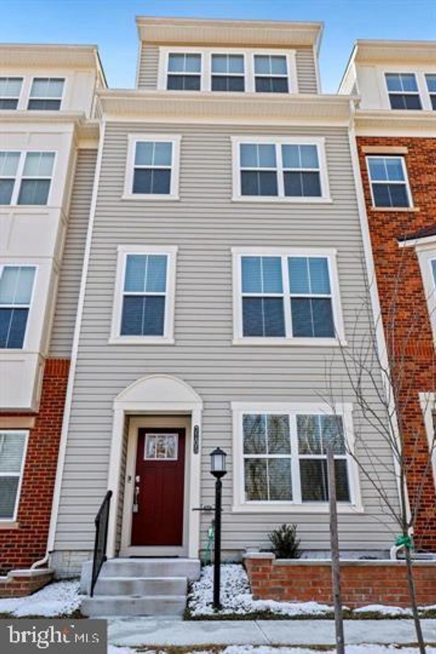 Scenic and corner house in the OXFORD SQUARE community. Welcome home to this exquisite 4-story smart home townhome with 4 bedrooms 4.5 baths, 1 car garage, and 2 decks in Oxford Square. The main level features a bright, open floor plan. A gourmet kitchen with upgraded granite counter space, stainless steel appliances, a gas range, and a granite breakfast island with bar height seating There is coffee bar shelving in the Dining area and a barn door slider that opens to a maintenance-free deck Living has a hidden HDMI for TV. This home offers upgraded, energy-efficient, green living. upgraded flooring throughout the home from wide plank wood floors on Entry and Main levels to the carpet on all upper levels. Private Owner retreat fitted with two large closets, and an en-suite bath. The owner’s bath has an oversized shower with a seat, dual sink granite vanity, linen closet, and private WC. This level also has Bedroom # 3 with a full bath. A bonus fourth-floor loft with a 4th bedroom suite, yet another full bath, and a recreation room with sliders to an expansive fourth-level deck! An entry-level Bedroom or family room with its full bath, and Laundry completes the inside of this well-designed home. A spacious one-car garage with built-ins provides extra storage. It is in amenity-rich Oxford Square with a community pool, clubhouse, fitness center, walking path, and top-rated elementary and middle schools. All are within walking distance. The free community shuttle ride to the Dorsey MARC Station is under two minutes from major highways to Baltimore and DC. Designed for healthy living, and privately nestled between green spaces.