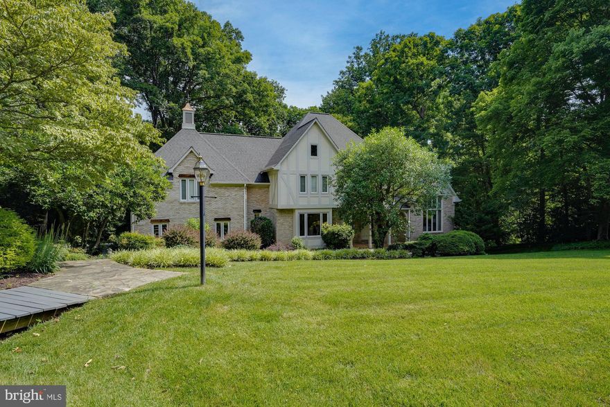 Stunning Monte West Tudor home in sought after Hunters Crest sited on a quiet cul-de-sac and a premium 1.81 acre lot. The sun-filled interior boasts 5 bedrooms, 4.5 bathrooms, 2 car side-load garage and 5,858 finished square feet over three levels. Attention to detail with $200K in updates, decorative moulding, hardwood flooring and recessed lights throughout. An entertainer’s dream with a grand foyer and curved staircase, open floor plan, formal living, and home office. Updated chef’s kitchen with a large island and high end appliances opens to the dining room. Inviting two story family room with stone fireplace. Luxury owner’s suite with dual walk-in closets and an updated spa-like en suite bath. A loft overlooking the family room, three additional bedrooms, and two full baths (one en suite) on the upper level. Finished lower level walks-out and boasts a game room with brick fireplace and built-ins, recreation room, wet bar, au pair suite with full bath and a laundry room. A true stay at home retreat with an expansive deck, walking trails, and fenced backyard surrounded by trees. This home has the best of everything! Amazing Vienna location close to Metro, parks, restaurants, shopping, and commuter routes. Top rated Sunrise Valley/Hughes/South Lakes Pyramid.