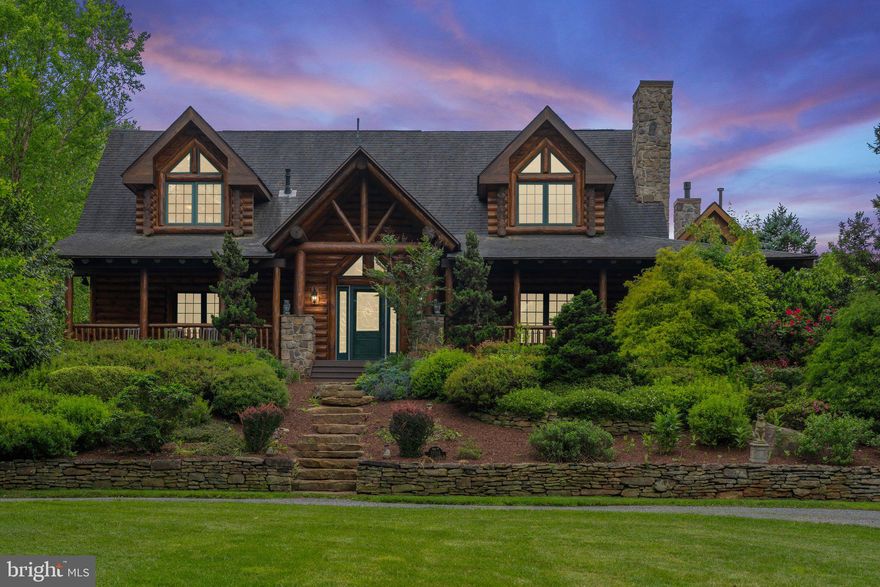 Escape to your own private haven nestled on over 35 acres of breathtaking natural beauty. This stunning log cabin retreat combines rustic charm with modern luxury, offering a serene sanctuary just moments from civilization. 
Step inside to discover a meticulously crafted 3-bedroom, 3.5-bathroom home boasting a spacious open floor plan, vaulted ceilings enhanced by exposed beams, and two inviting stone fireplaces. The heart of the home is the custom kitchen, complete with a large island, granite countertops, and brand-new stainless-steel appliances.
Relaxation awaits in the adjacent sunroom, where expansive windows and skylights flood the space with natural light, perfect for indoor gardening or simply unwinding with a good book. The main level primary suite offers a private oasis with a luxurious ensuite bathroom, featuring a tile shower, separate jetted tub, and access to a covered porch overlooking a tranquil Koi pond (Koi included)
Upstairs, two additional bedrooms, an office, and a large full bath provide ample space for family and guests. The basement level offers endless entertainment possibilities with an oversized recreation room, home gym, another full bath and a game room complete with the included billiard table. Also included is a whole house generator and water treatment system.
Outside, explore miles of private walking trails winding along the picturesque Muddy Run stream, or practice your swing from the tee box  or on the putting green. Sports enthusiasts will appreciate the basketball court with tennis wall, while car aficionados will love the detached conditioned four-car garage with bonus room alongside a second two-car garage.
With a separate 21.8 acre wooded lot included, eligible for division according to current zoning ordinances, the possibilities are endless. Don't miss your chance to experience true log cabin living at its finest. Fiber optic internet available, no HOA/covenants.