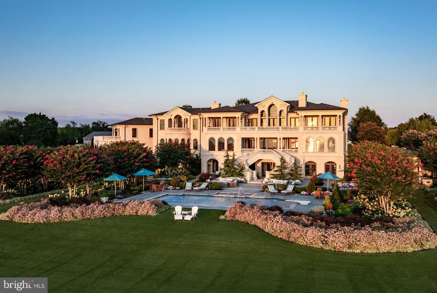 Commanding 18.67 private acres with sweeping views of the Chesapeake Bay and its iconic bridge, 200 Bridgeview Lane is a world-class waterfront estate of unprecedented scale and refinement. The residence harmonizes architectural grandeur with the serenity of coastal living.
 
Approached through a gated drive that unfolds past manicured lawns and sculpted gardens, the property immediately establishes a sense of privacy and prestige. Every detail, from the hand-forged ironwork to the precision of its stone craftsmanship, reflects a commitment to excellence that is timeless and enduring.
 
Inside, a dramatic double-height foyer reveals hand-milled trim, wrought-iron accents, and mahogany floors inlaid with imported stone. Expanses of glass capture 180-degree views of the Bay, drawing natural light into every corner and framing the horizon as a living work of art. Formal and informal living spaces flow effortlessly, united by coffered ceilings, bespoke millwork, and a sense of balance between grandeur and comfort.
 
The gourmet kitchen is an entertainer’s masterpiece, anchored by custom cabinetry, professional-grade appliances, and a central island designed for gathering. It opens seamlessly to the grand parlor and a series of multi-tiered terraces overlooking the Bay, surrounding a heated pool and spa. Beyond, an outdoor pavilion with a summer kitchen, bar, and cascading fountains sets the stage for unforgettable entertaining beneath open skies.
 
Occupying nearly 2,500 square feet, the primary suite serves as a sanctuary of peace and indulgence. It features a fireplace, sitting area, private office, and a terrace that captures sweeping water views. A spa-inspired bath with heated floors, dual vanities, soaking tub, and a marble shower complements a custom dressing room designed with meticulous detail. Each guest suite throughout the home is equally refined, offering its own private bath and distinctive character, ensuring every visitor experiences the same sense of thoughtful luxury.
 
From the home’s state-of-the-art amenities to its effortless connection to the Chesapeake, this is an estate conceived not only for living but for legacy.
 
Located just moments from Washington, D.C. and Baltimore, yet feeling worlds away, 200 Bridgeview Lane stands as a rare offering of seclusion, scale, and sophistication, where architectural artistry meets the infinite beauty of the Bay.