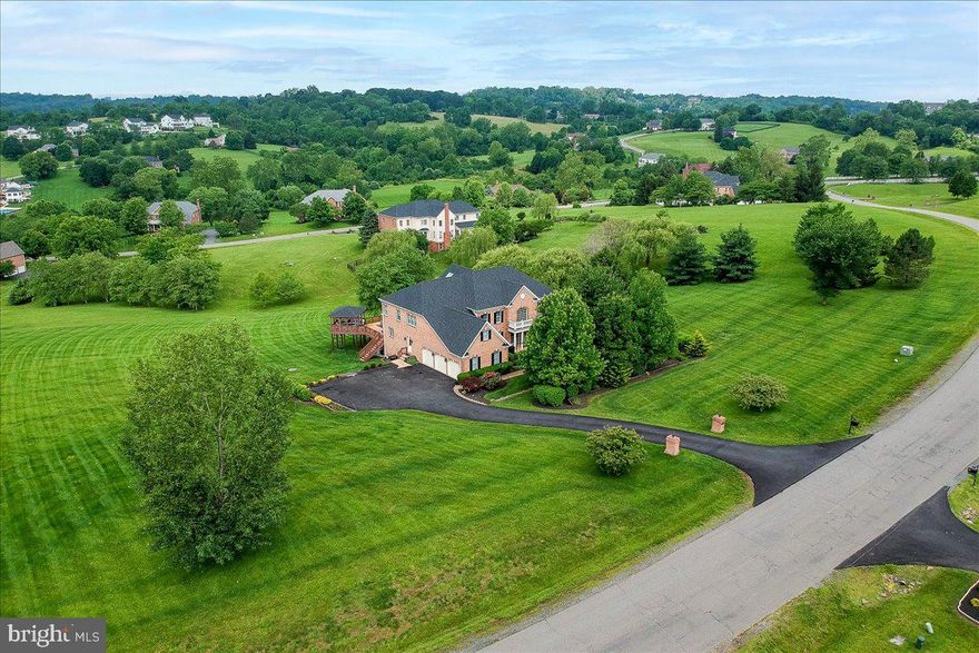 Beautiful estate home in scenic Shenstone Farm, with its rolling hills and scenic skylines, yet just minutes from Downtown Leesburg and all its shops and restaurants. The home is almost 8,000 finished square feet sitting on 4.82 acres, featuring 6 Bedrooms and 6.5 Baths, and has tons of recent updates. The grand entrance, two-story foyer features a new Marble floor (2025), and an elegant dual, curved staircase. Spacious two-story family room with a gas fireplace and new Hardwood Floor (2025), skylights, and window package, provides the main level with a ton of natural light. Separate Living and Dining rooms with new Hardwood Floors (2025), moldings, custom paint (2025). Huge Gourmet (and completely updated, 2023) Kitchen features Hardwood Floors (2025), Quartz counters, Cabinet doors, smart Upper and Under Cabinet Lighting, Stainless Steel Appliances, Thermador Cooktop and Downdraft Range Hood, Cafe Refrigerator, Cafe smart double Wall Oven, and Bosch dishwasher. A large Sunroom next to the kitchen has skylights and opens to a large 2-tiered deck at the back, which includes a Gazebo. First-floor office with custom shelves. Updated Powder Room (2025). Great Room/Conservatory, perfect for relaxing in or having a second First-floor office. Upper Level includes all new Hardwood Floors (2025), Four Spacious Bedrooms, with all 3 secondary bedrooms featuring their own updated Full Baths (two in 2024) and new Ceiling Fans. Massive Primary Suite with Sitting Room, 2 Large Walk-in Closets, Primary Bath with Lighting and Vanity upgrades. The Fully Finished Walk-out Basement features 2 additional bedrooms, with a Separate Playroom or Gym, an additional full bath, and a Gas fireplace. Gorgeous hand-scraped Hardwood floors throughout the rec room with a Custom Bar, Theatre Room, and In-Law Suite.
All Updates with year completed include New Roof and Attic Fan (2023), HVAC (2019), Hot Water Heater (2020), updated Water treatment system (2023), new Well Tank (2022), Steam Humidifier added (2020), Hardwood Floors on Main and Upper Level (2025), Marble in Foyer and Powder Room (2025), 5 Elegant Chandeliers (2020), Extended Driveway and Repaving (2023), Landscaping (2023), All 3 Garage Doors replaced (2025), Smart Garage Door Openers (2020), Secondary Baths and Powder Room (2024/2025), Majority of House Painted (2025), new Metal Balusters and Carpet Runner (2021).